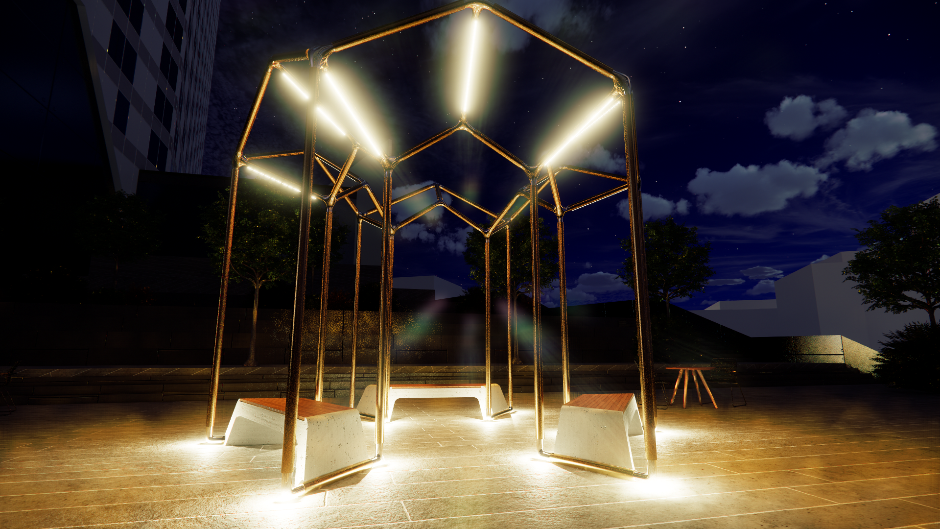 Nighttime outdoor scene featuring illuminated modern art installation with metal geometric structures and benches on a wooden deck, with trees and a tall building in the background under a starry sky.