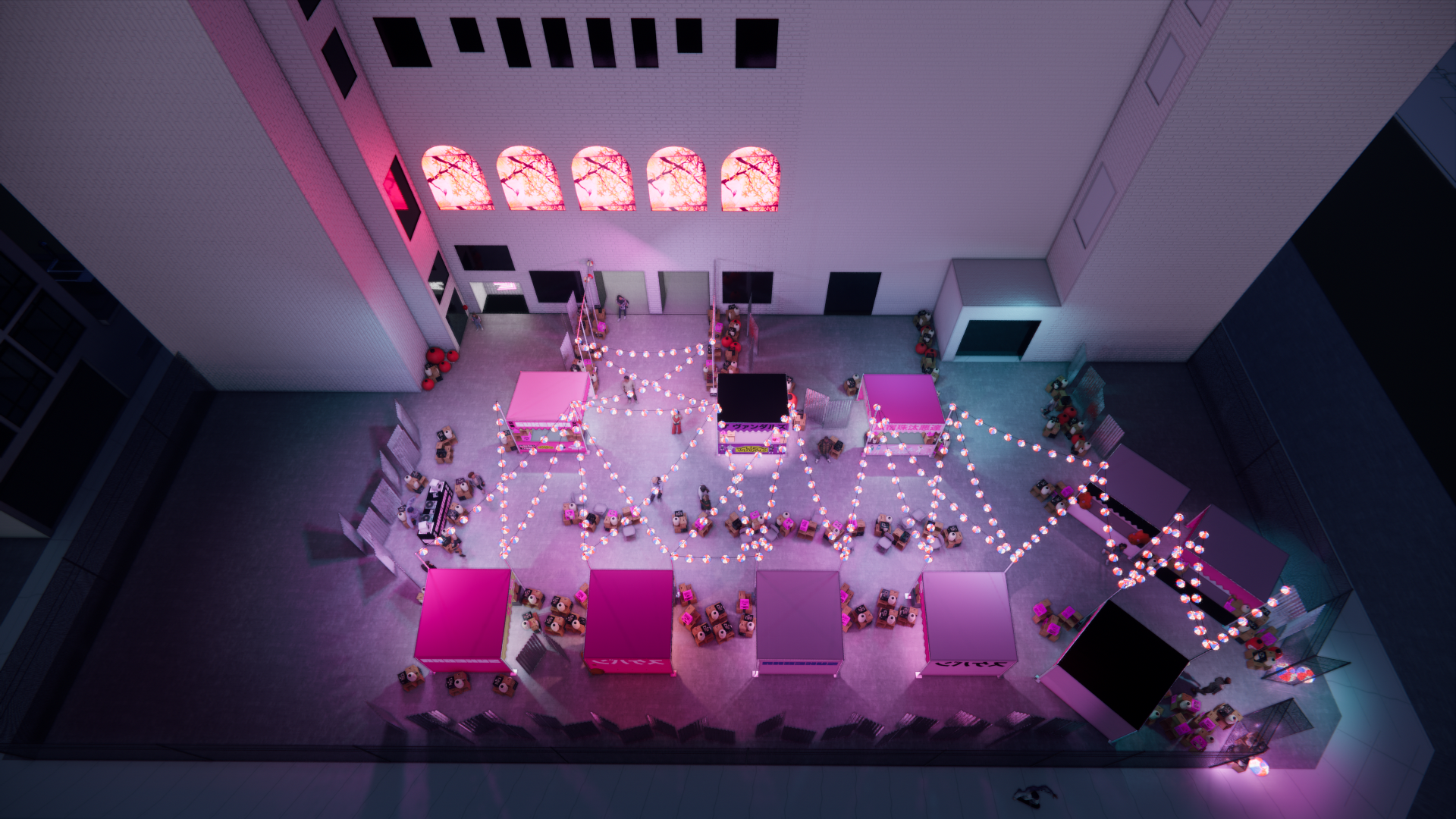 A top-down view of an outdoor event space decorated with pink and white string lights, pink booths, small tables with chairs, and stacked cardboard boxes scattered around. The space is illuminated with pink lighting, and there is a wall with five ill
