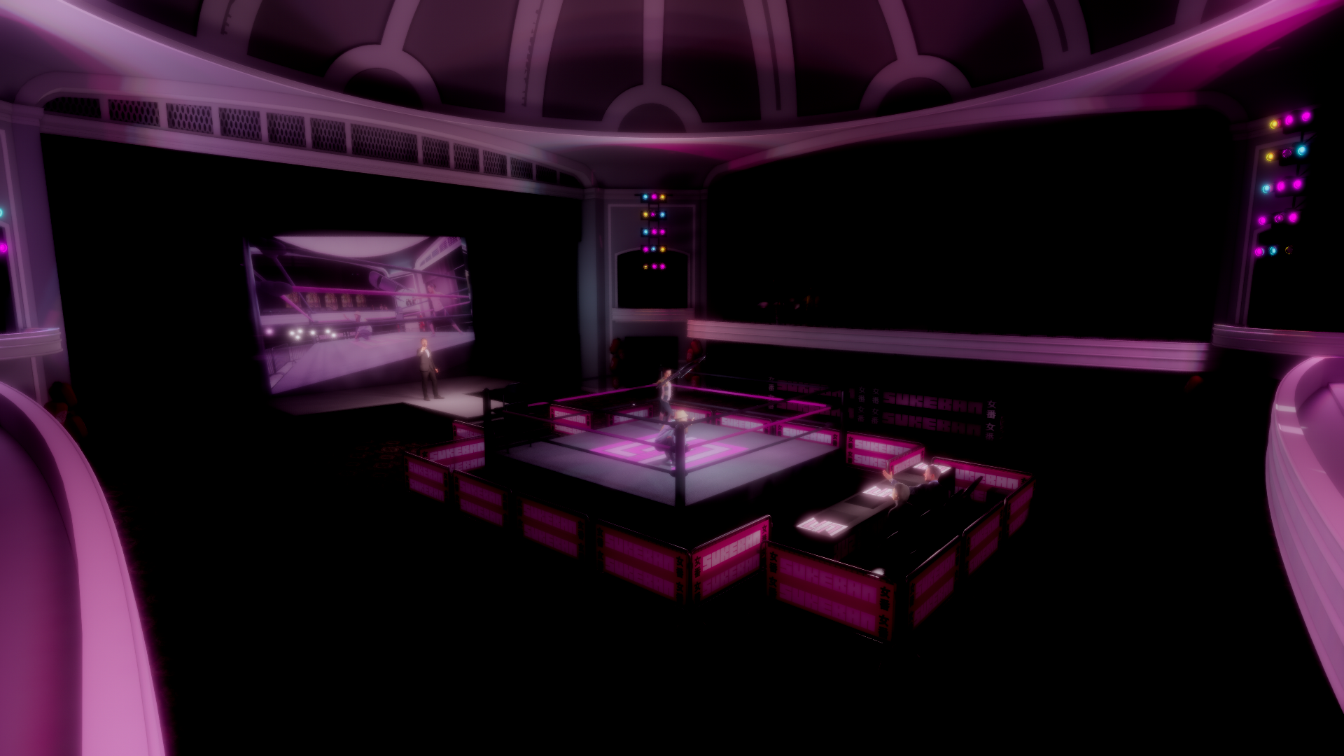 A professional wrestling ring illuminated with pink lights inside a decorated theater with purple and pink lighting, with a large screen displaying a wrestling match and a woman speaking on stage.
