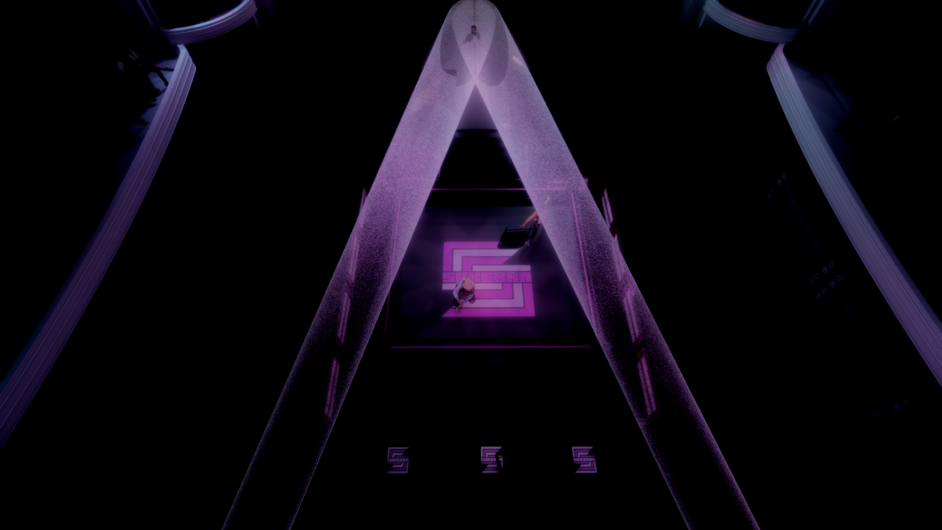 Aerial view of a person standing on a neon-lit maze pattern on the floor in a dark room with purple lighting and tall pillars.