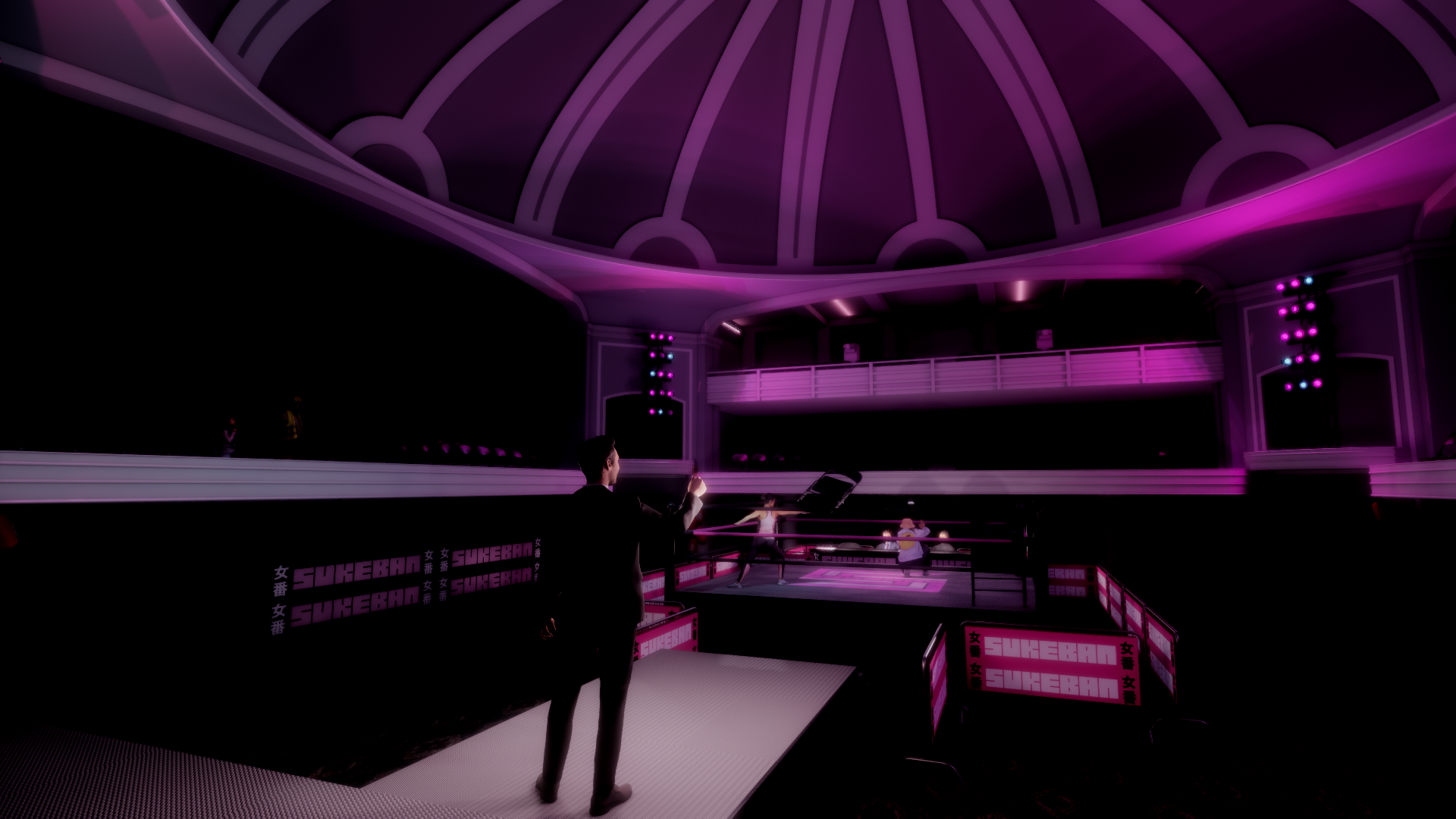 An indoor boxing ring with pink lighting and banners that read "SUKEBAN". Two women are training, two men are observing, in a spacious, modern venue with a high domed ceiling.
