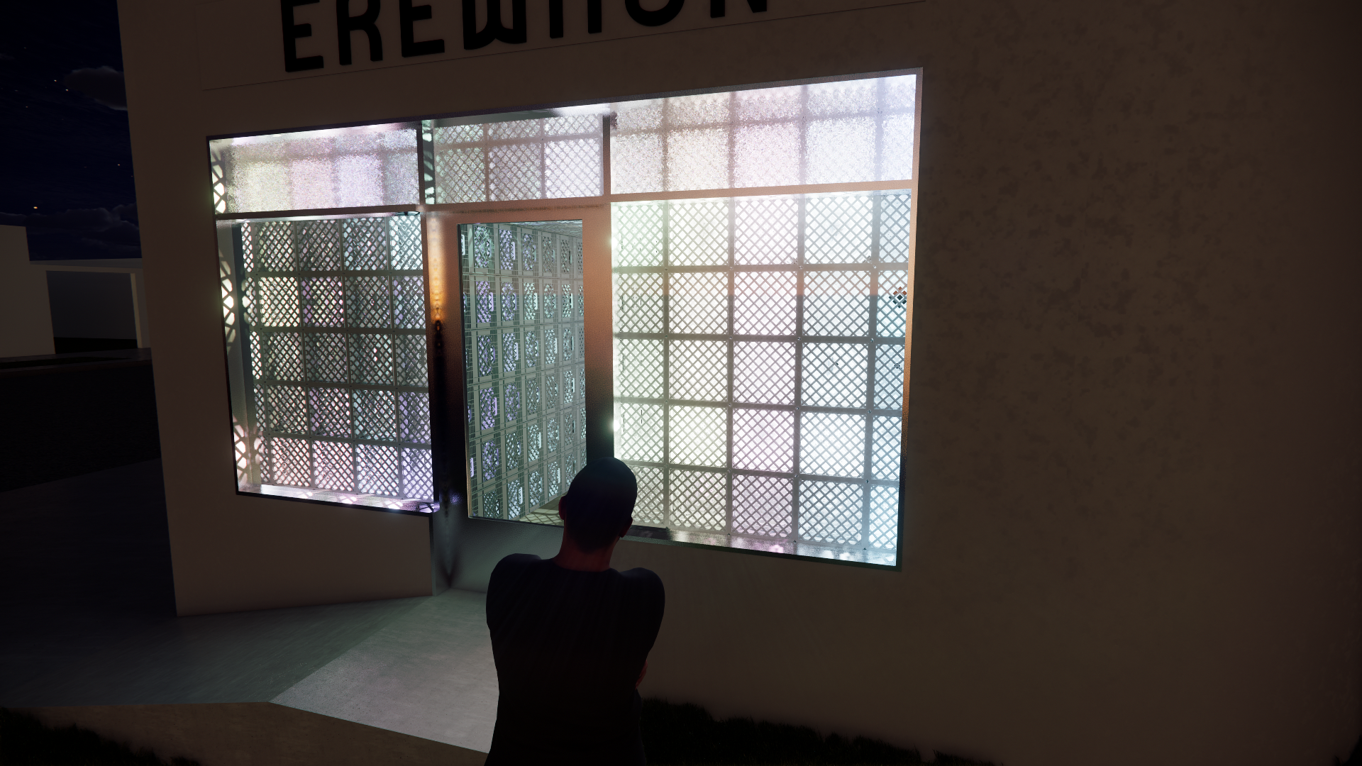 A person with short dark hair, viewed from behind, stands in front of a large illuminated art display that features a grid pattern with intricate designs, framed by a wall with a sign above reading "ERERUTOP".