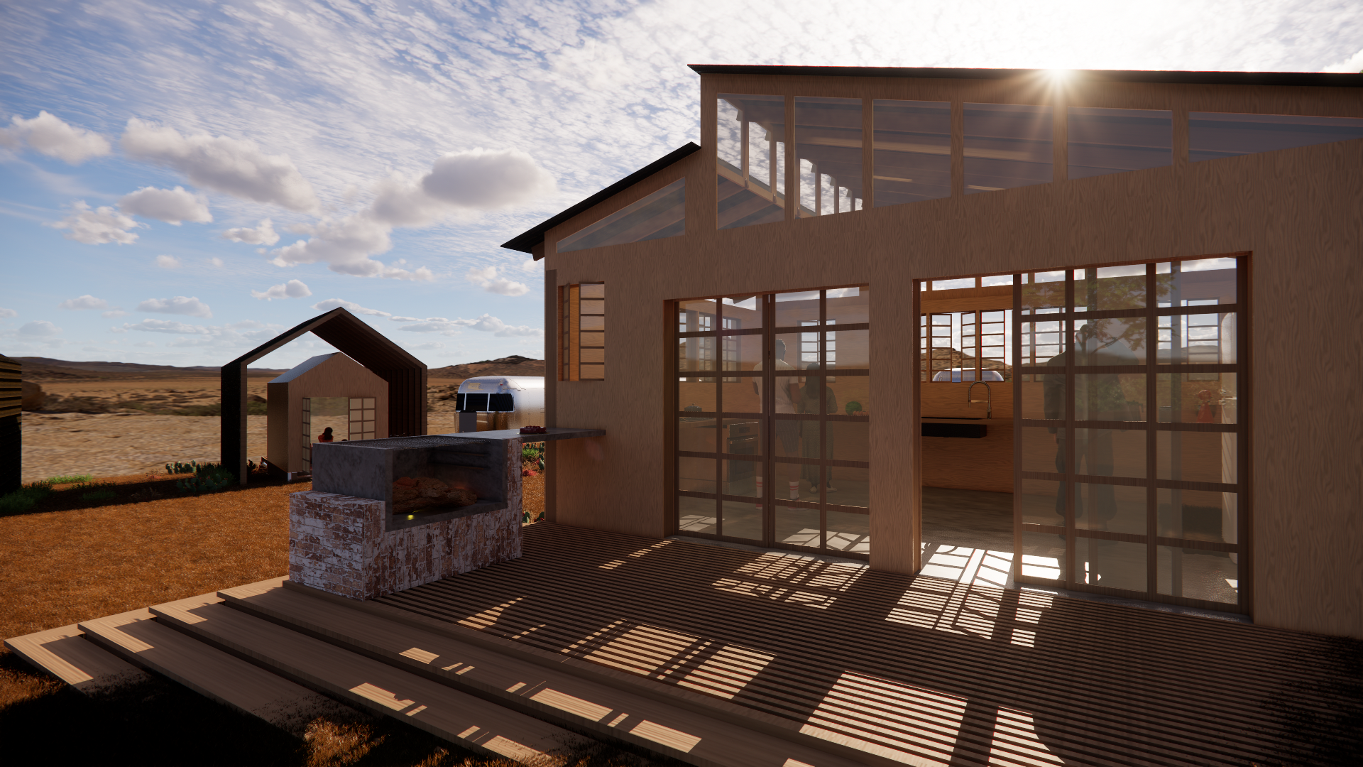 Modern wooden house with large glass windows, a deck, and an outdoor kitchen area with a brick oven, set in an open, arid landscape with a clear sky and scattered clouds.