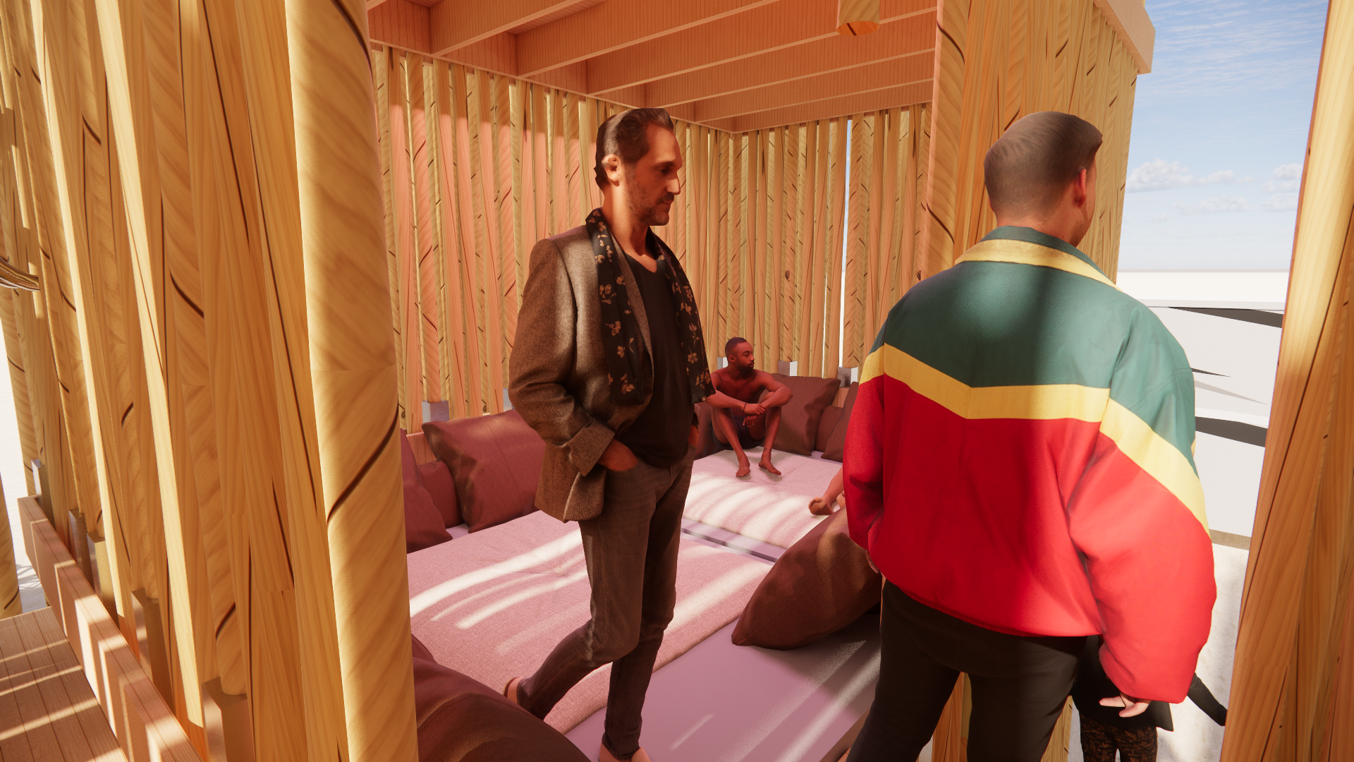 Three men inside a wooden room; two are standing and one is sitting on a bed behind them. The man on the left has his hands in his pockets, wearing a blazer and scarf. The man on the right has a colorful jacket. The person on the bed is shirtless, si