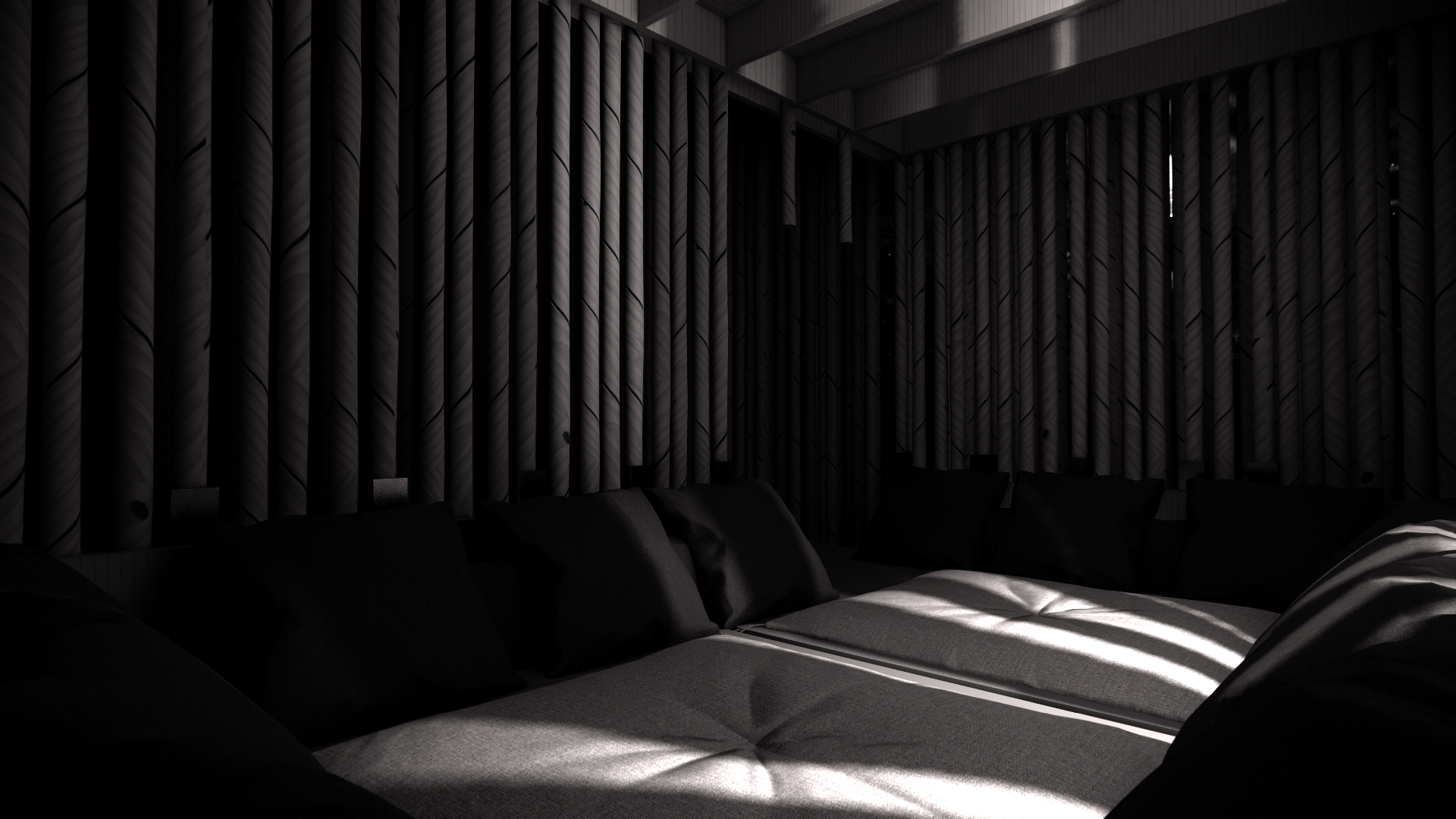 A cozy living room corner with a gray couch and black cushions positioned against a wall with black textured vertical paneling, illuminated by natural light casting striped shadows across the furniture.