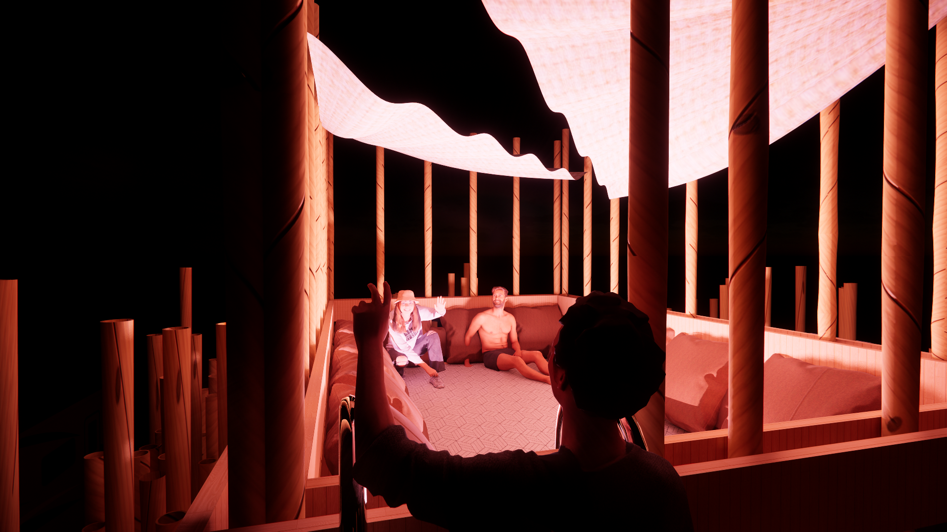 Two people sitting on a cushioned ledge inside a room with glowing pink and orange lighting, with a wooden railing in the foreground. One person is shirtless and the other wearing a hat and glasses.