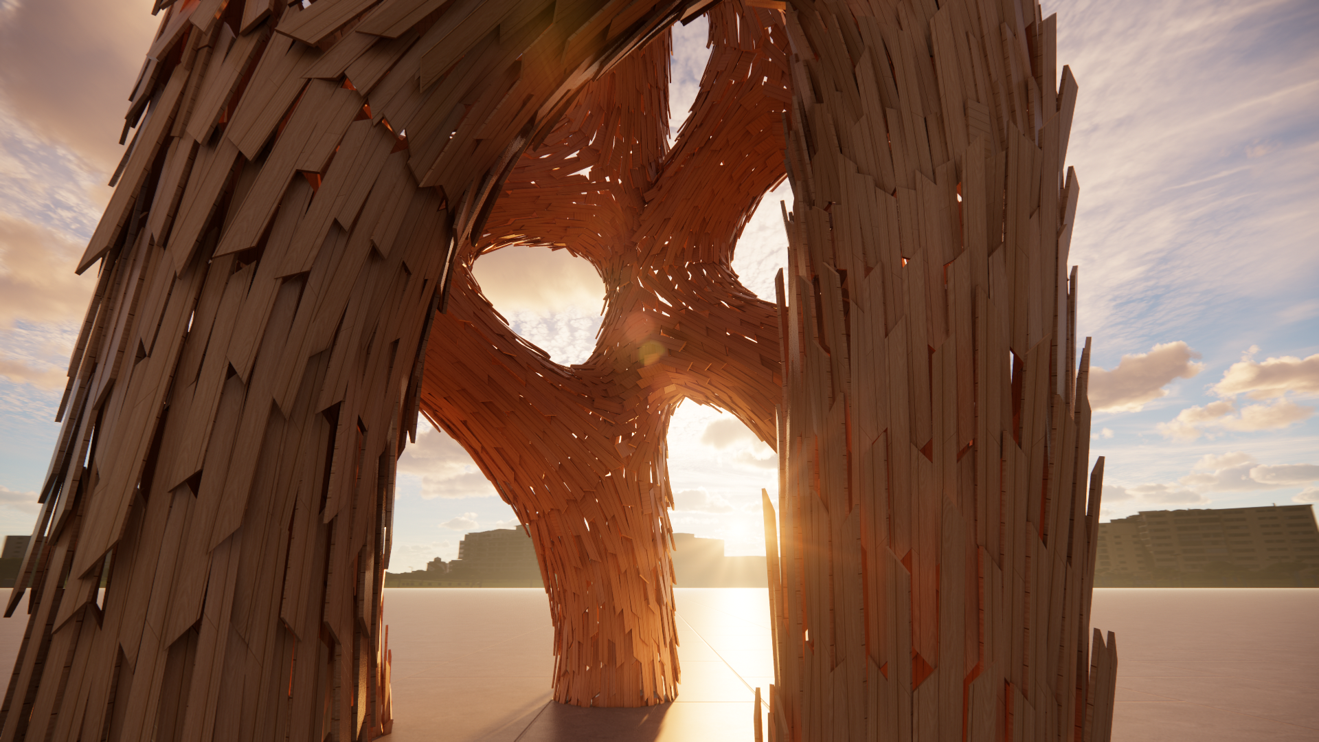 A large wooden sculpture with multiple vertical planks arranged to form an abstract, flowing shape, with the sky and clouds visible in the background during sunset.