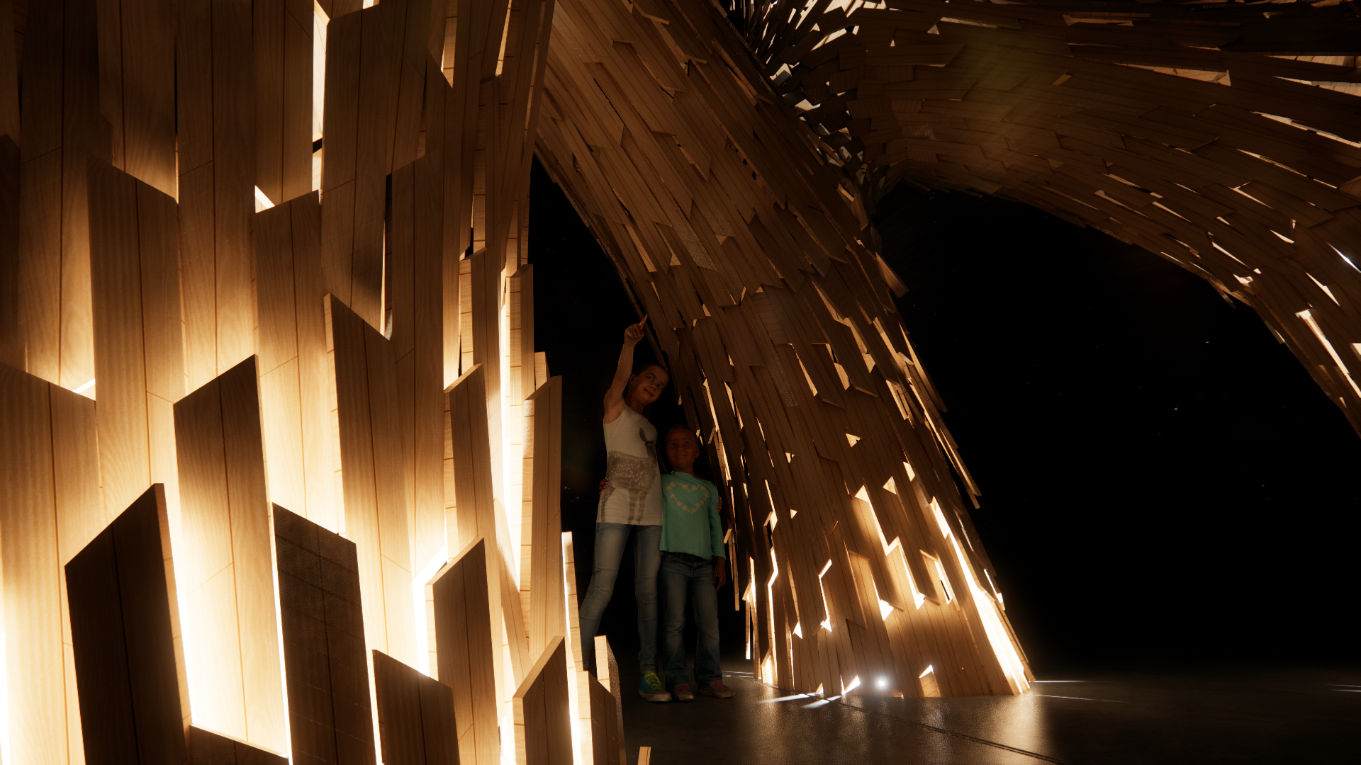 Two children standing inside a large, curved wooden structure with backlit panels, at night.