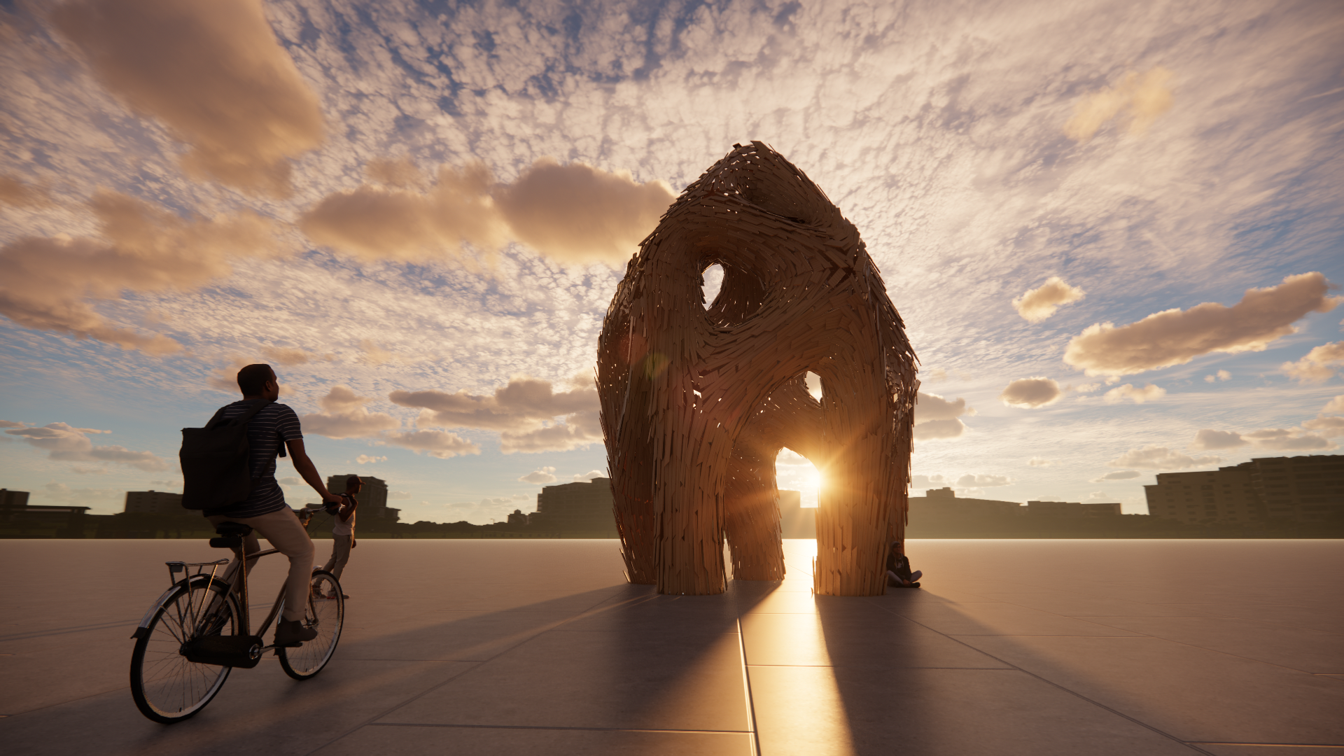 People riding bicycles near a tall, abstract wooden sculpture with the sun setting behind it, casting a warm glow.