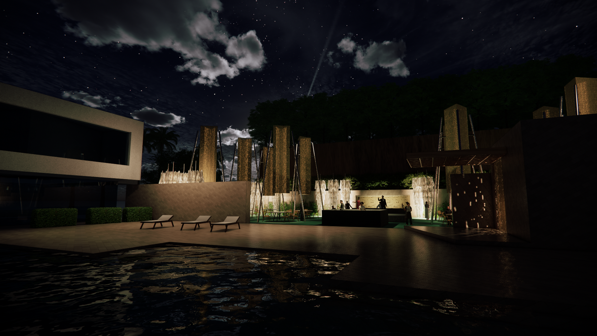 Night view of an outdoor area with a pool, lounge chairs, and a modern building in the background. There are vertical wooden structures, a small waterfall feature, and people gathered in the illuminated area, with a starry sky and clouds above.