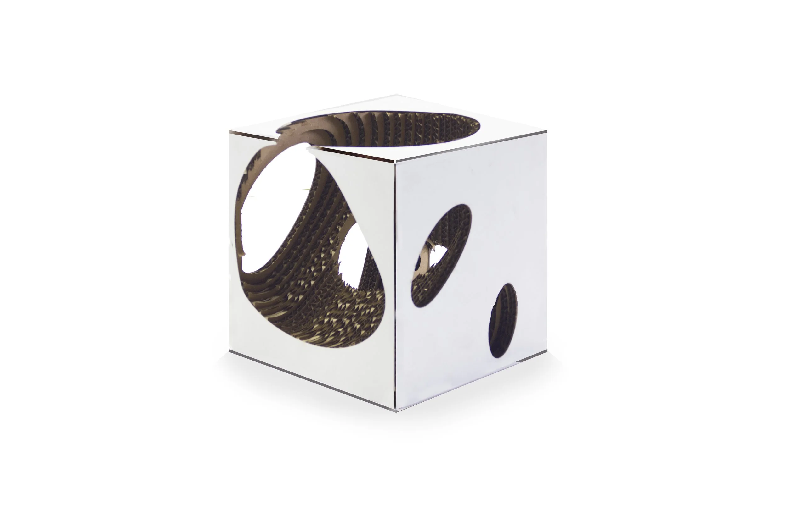 A white cubic box with circular cutouts on each side, revealing a textured interior material.