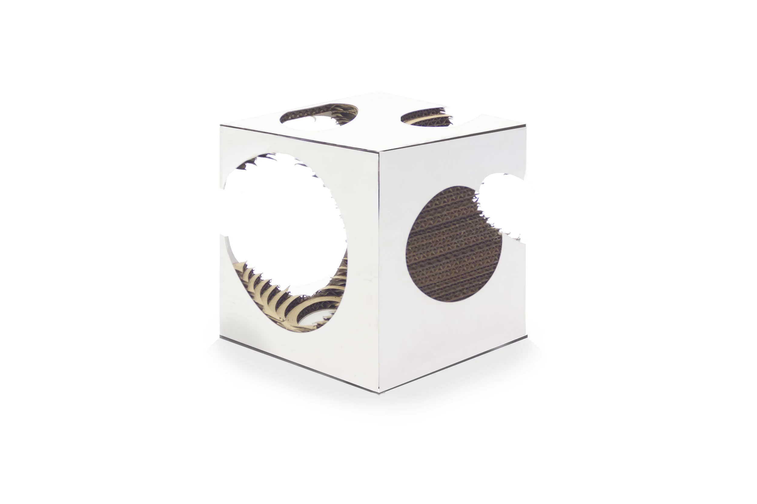 A cardboard cat scratcher cube with circular cutouts on each side, layered with corrugated cardboard for scratching.