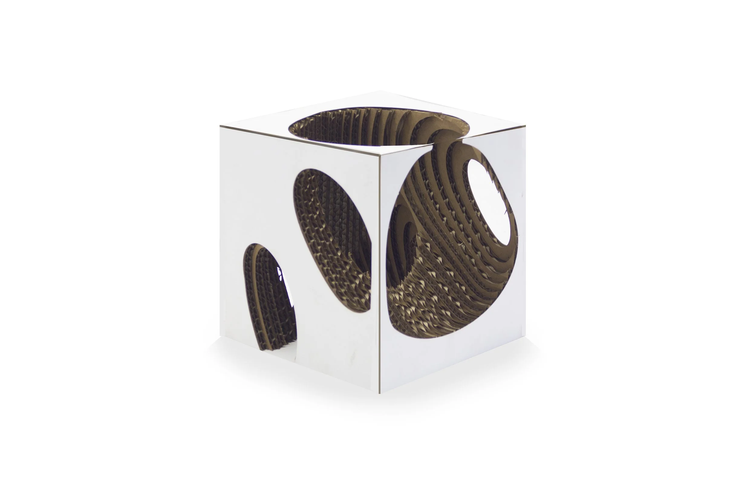A white cube with circular cutouts on each side, revealing a layered, honeycomb-like brown interior structure.