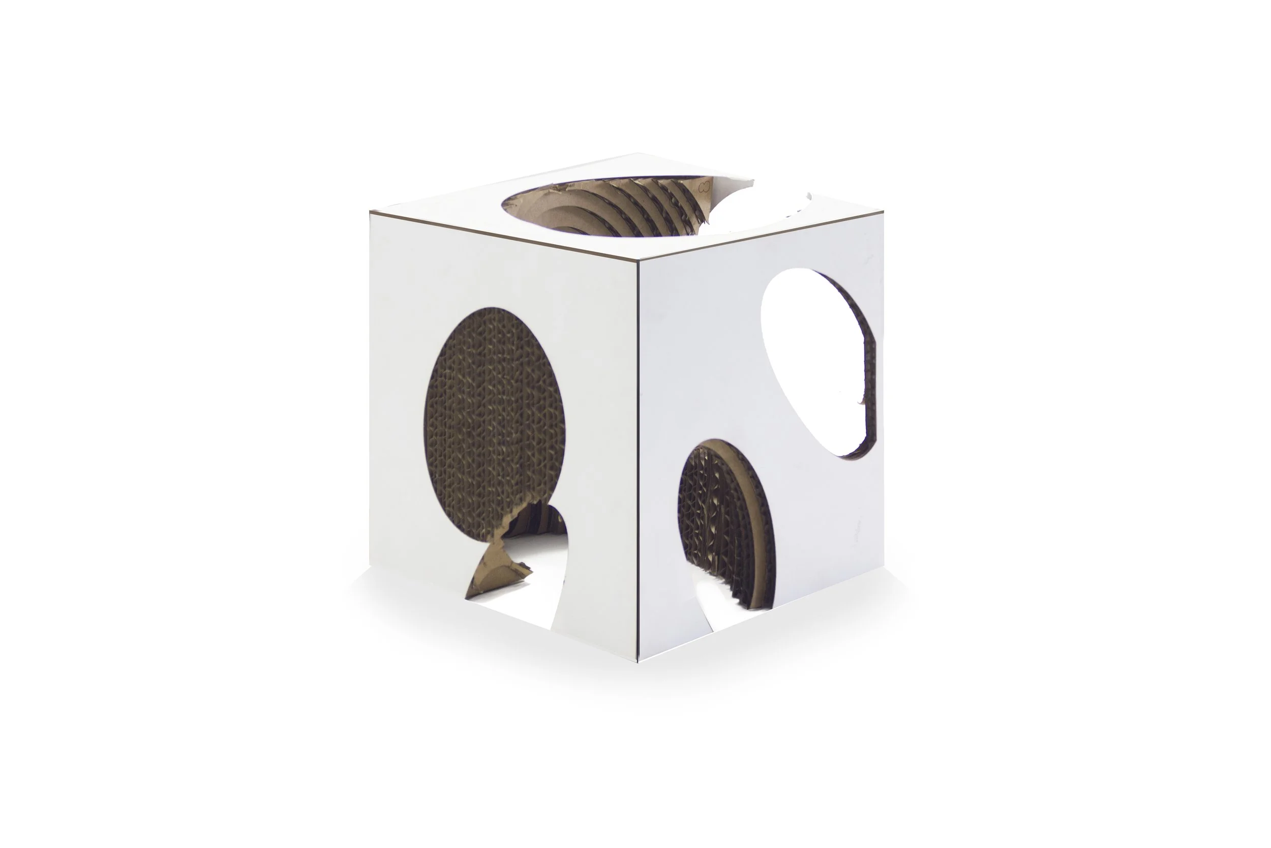 A white cardboard box with circular cutouts revealing honeycomb-like material inside.
