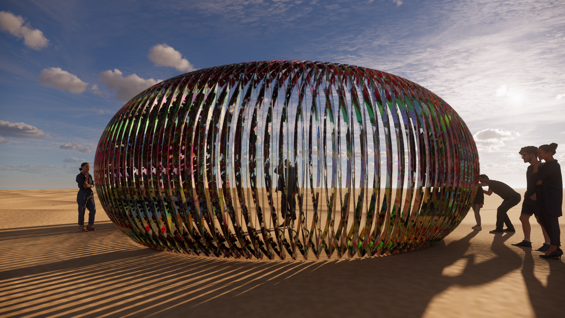 People gathered around a large, colorful, oval-shaped art installation made of vertical, reflective strips on a sandy outdoor area under a sky with scattered clouds during sunset.
