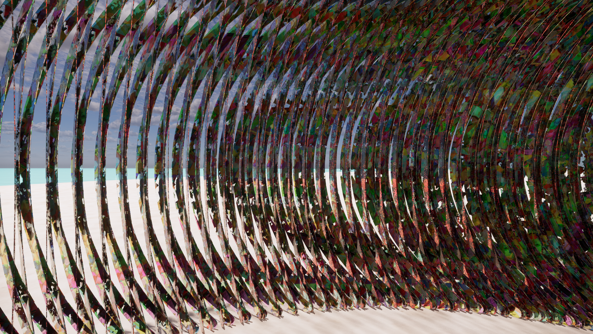 A modern outdoor art installation composed of large, curved metallic ribbons with reflective and colorful surfaces, set against a partly cloudy sky and a beach with sand and sea in the background.