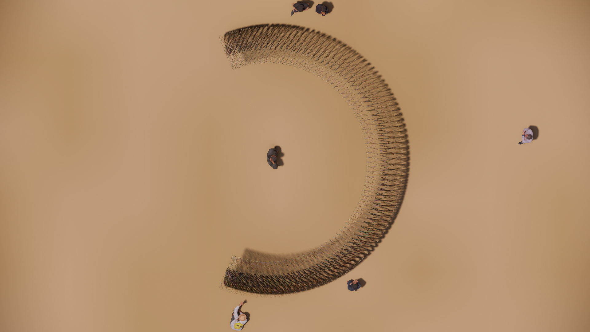 Bird's eye view of a curved string art installation on a beige surface, with several people standing around it, some observing and others taking photos.