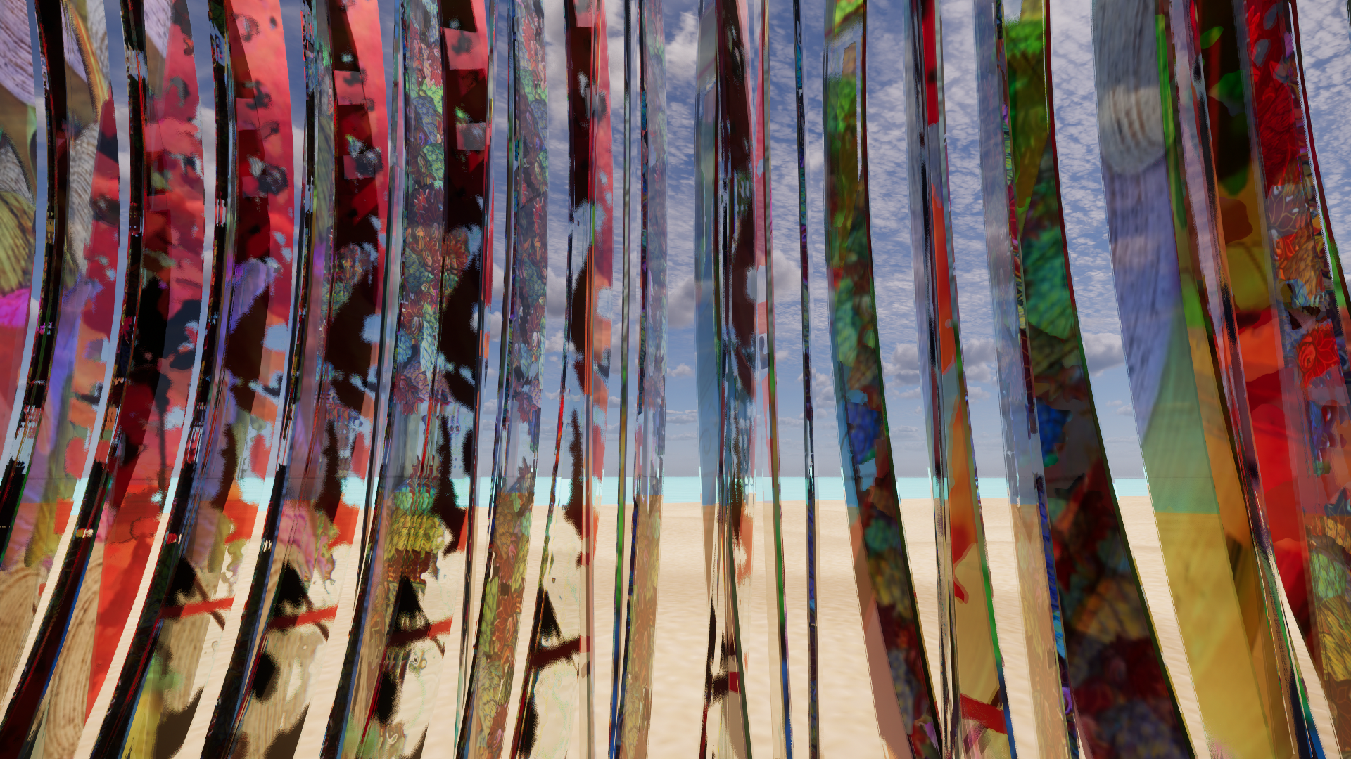 Colorful vertical art installation on a beach with sand and ocean in the background and a cloudy sky overhead.