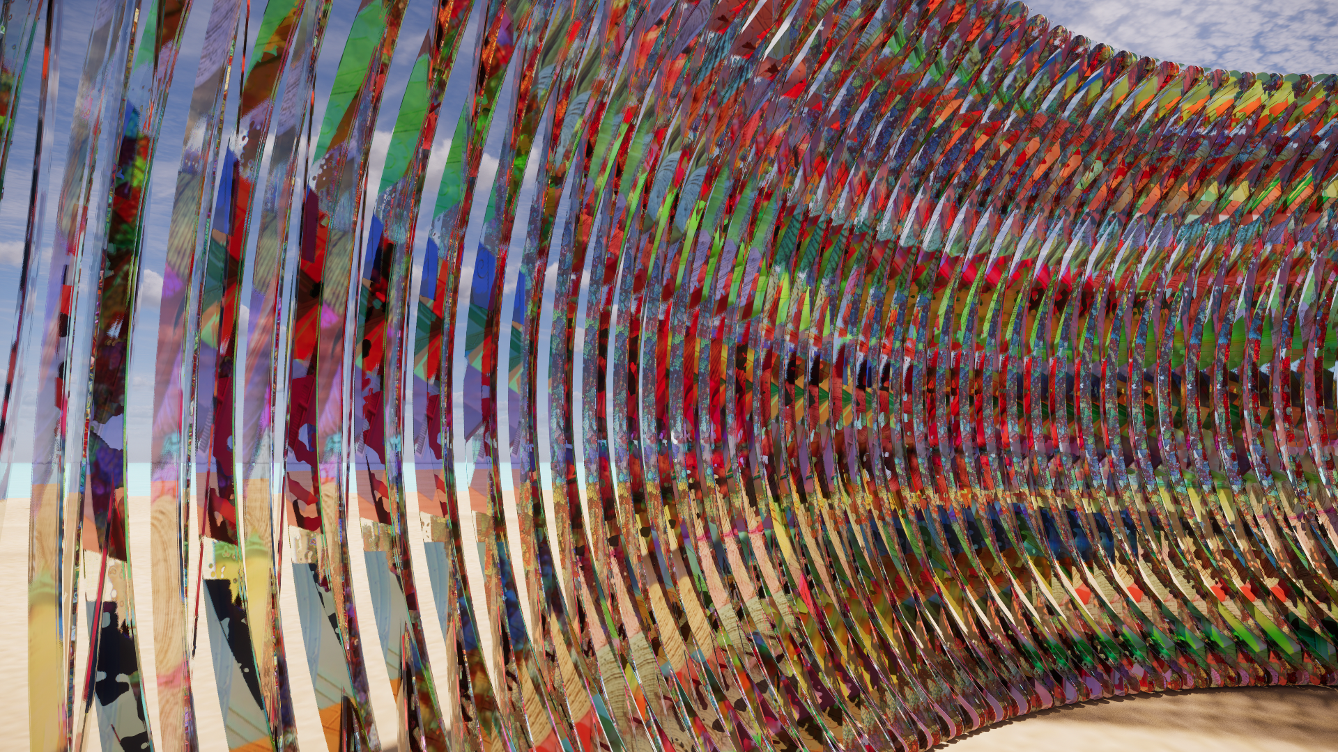 An outdoor sculpture consisting of colorful, curved metal slats arranged in a tunnel-like structure against a partly cloudy sky.