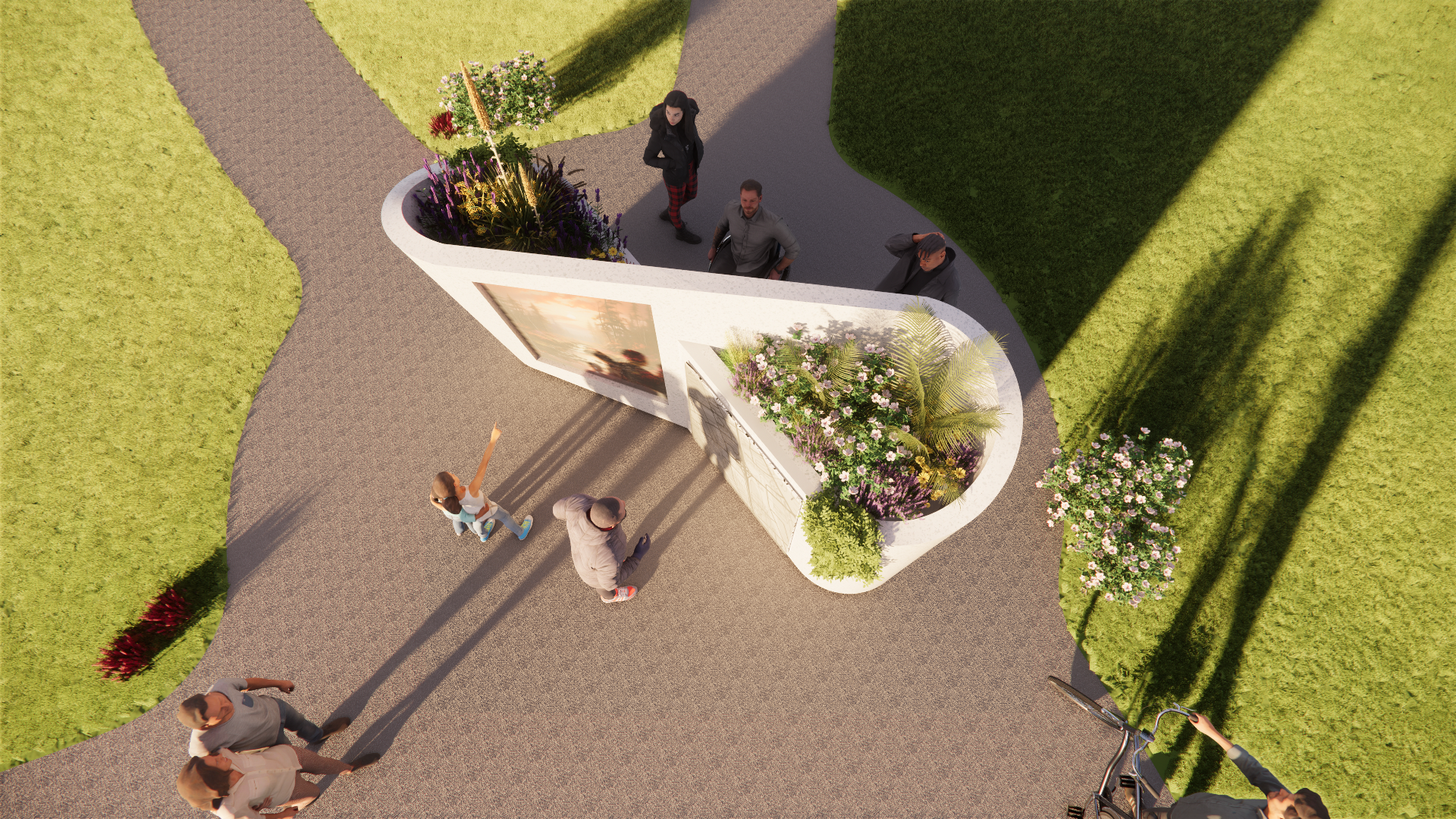People gathered around an art installation with flowers and a photograph, on a paved pathway surrounded by grass and bushes.