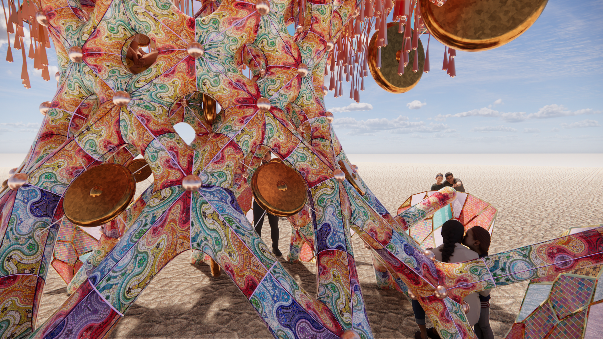 A large, colorful, geometric art installation resembling a star or flower shape with intricate patterns and hanging metallic elements, situated in a desert landscape with a clear blue sky. Several people are interacting with or observing the installa