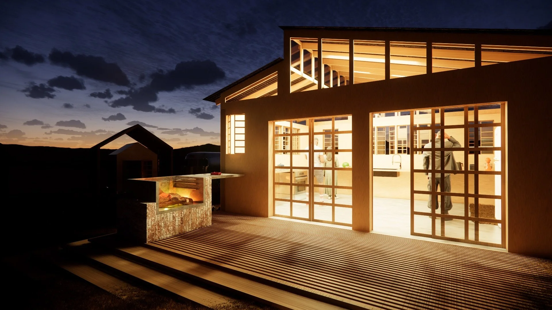 A modern house with large glass sliding doors and windows, illuminated from inside, at dusk or night. The house is on a deck with a striped surface, featuring an outdoor fireplace or fire pit area with a grill. Inside, people are visible, talking and
