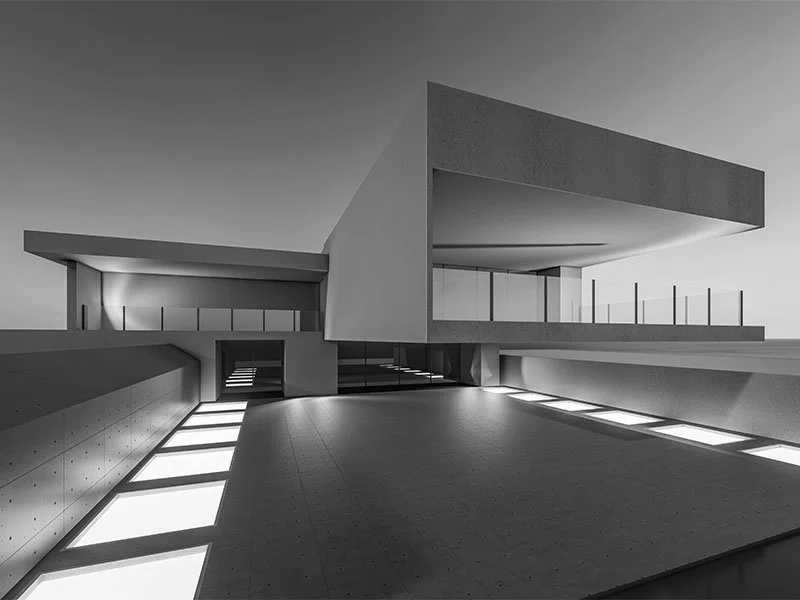 Black and white photo of a modern, minimalist building with geometric shapes and large overhangs, featuring a spacious open area with light coming through rectangular floor openings.