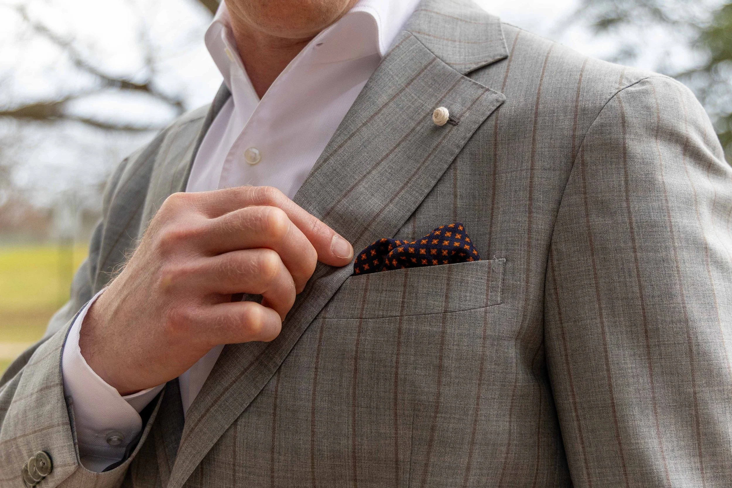 Curated classic men's wardrobe essentials including dress shirts, ties, and leather belts