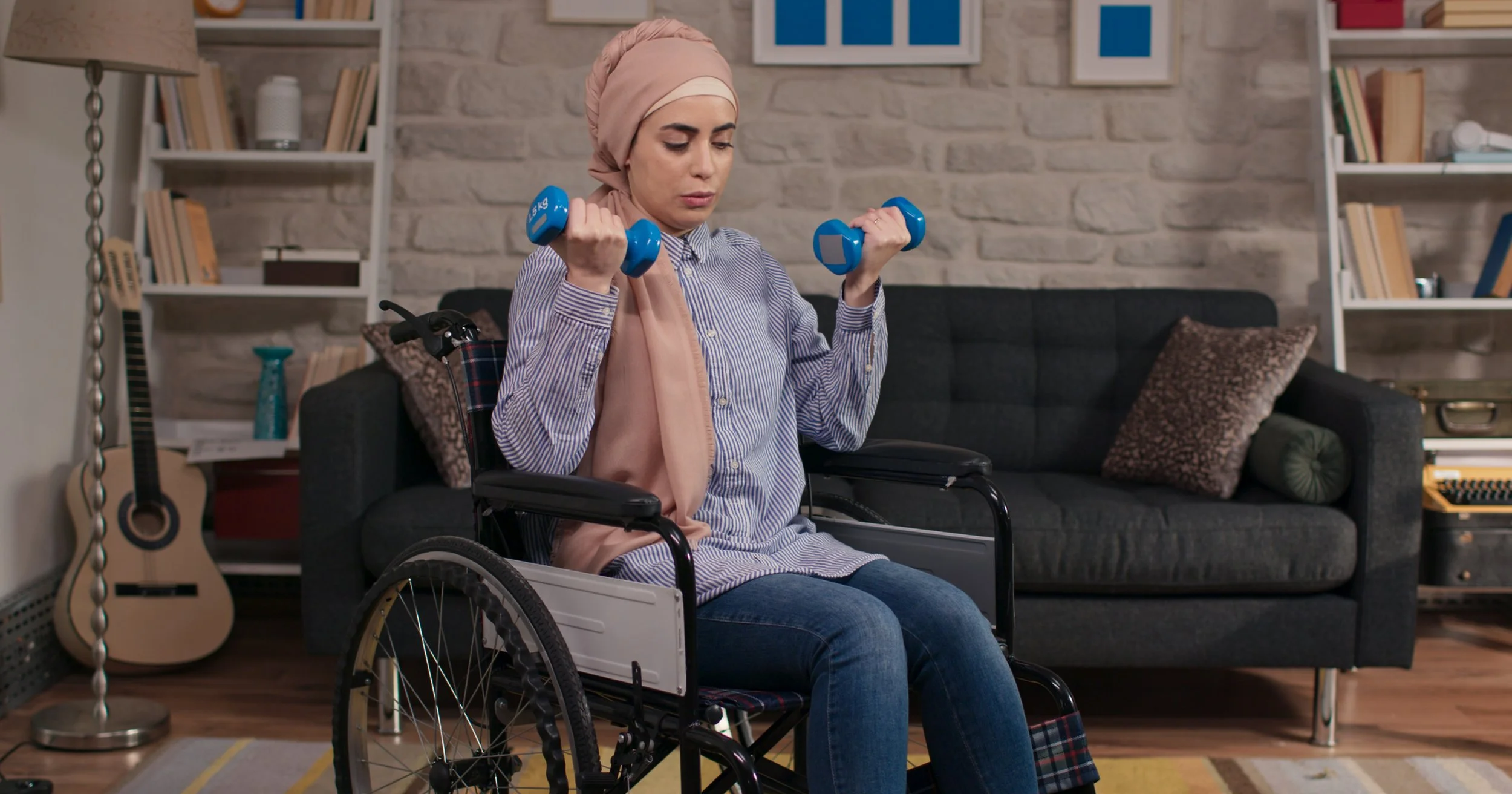 Woman with burka in wheelchair lifting weights