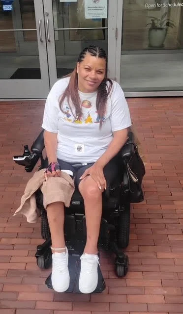 Woman sitting in wheelchair smiling