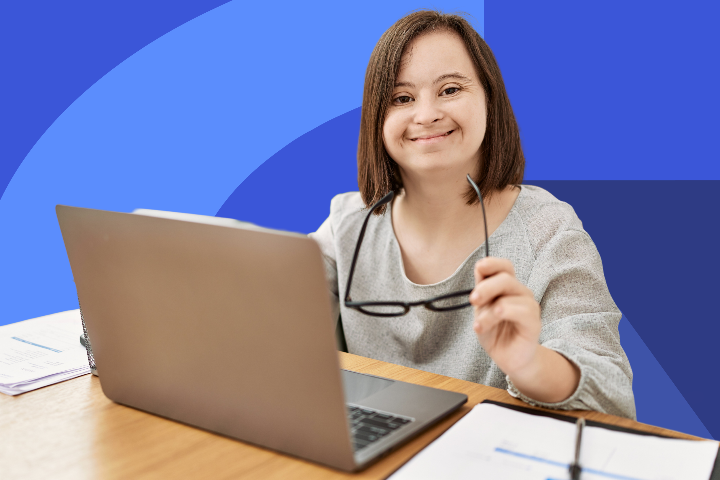 Volunteer with downs syndrome participating in a virtual meeting, smiling during an online outreach session with Disability Partnerships.