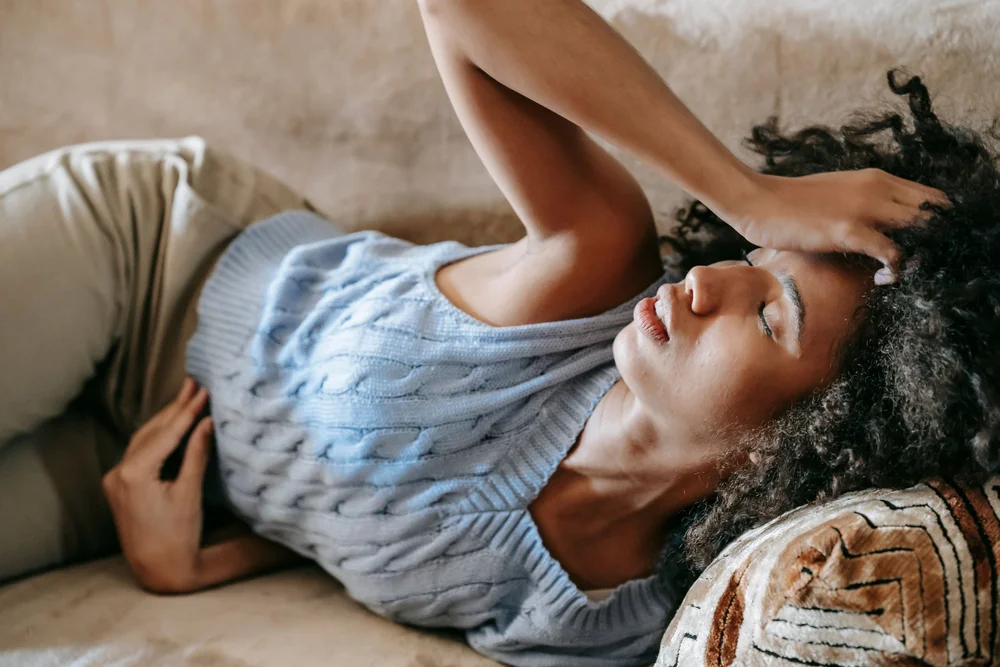 A woman lying down looking tired