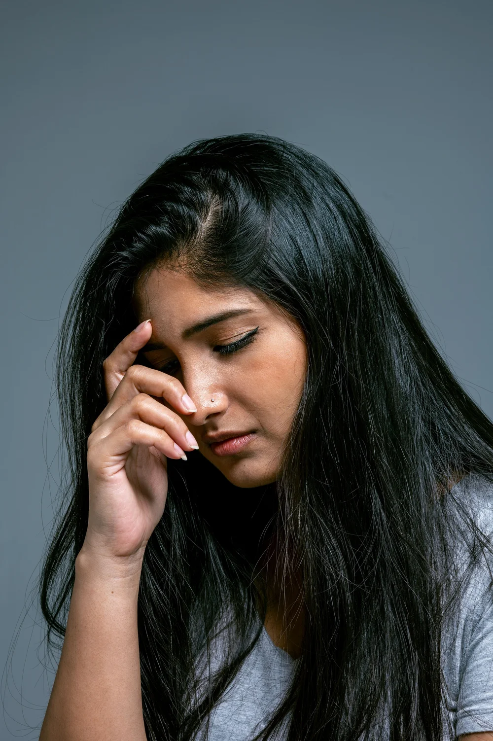 A woman wiping her eyes