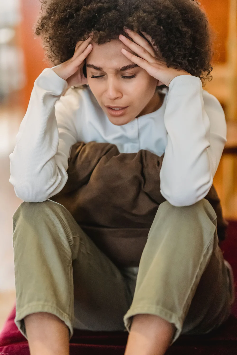 A woman holding her head in her hands