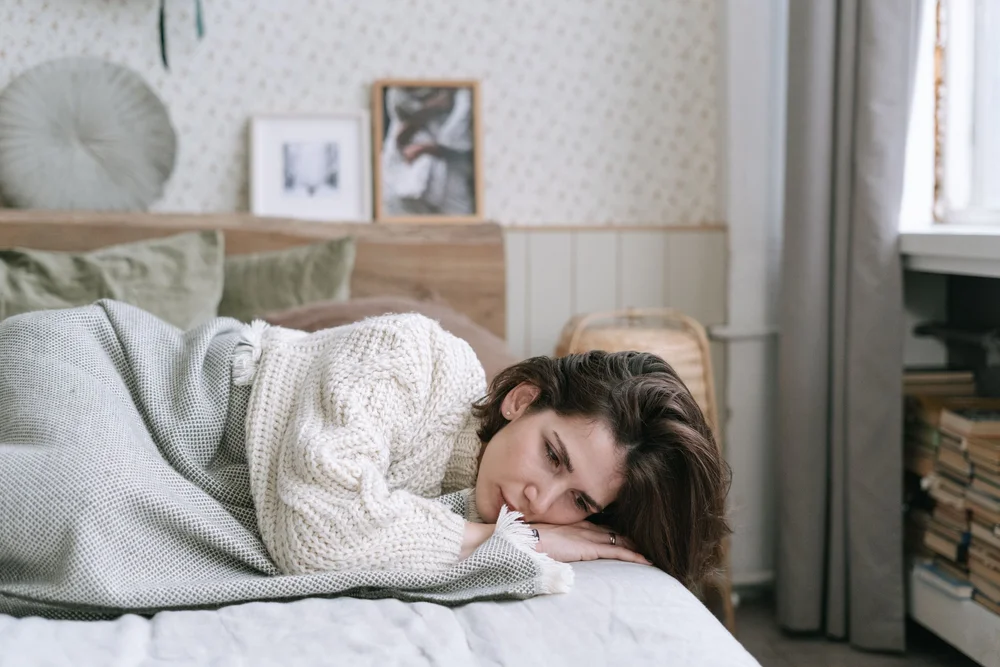 A woman lying in bed in soft light