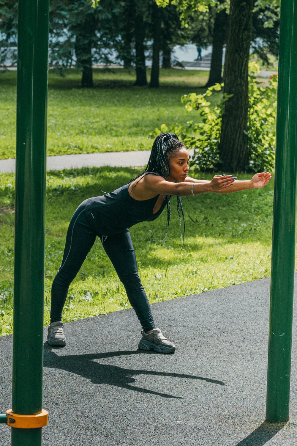 A woman stretching with arms wide in a park