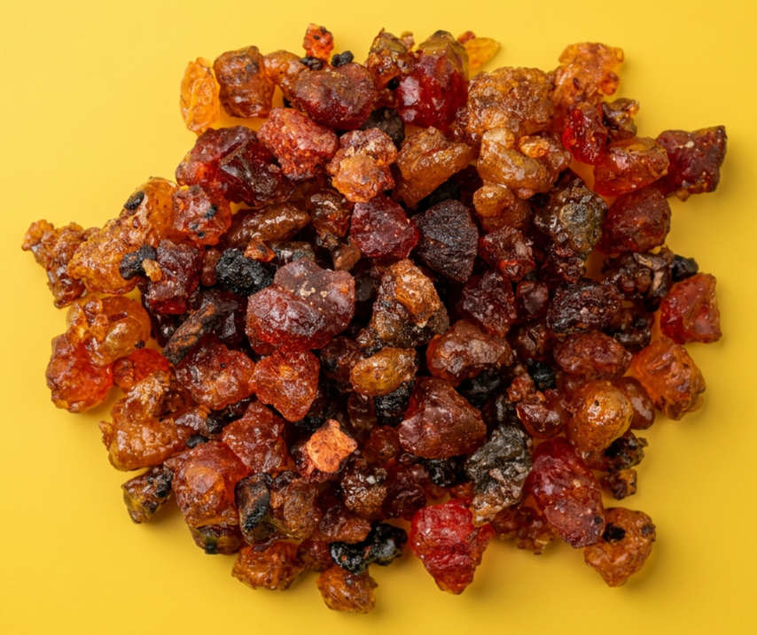 Cluster of dried, roasted chili peppers on a yellow background.