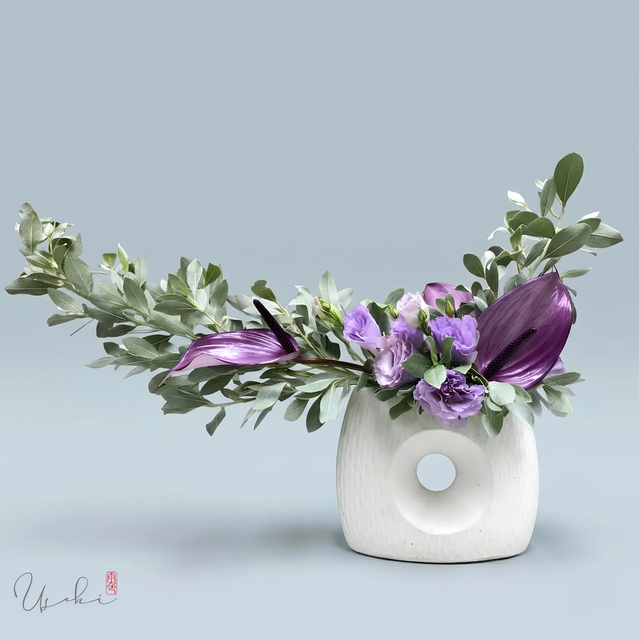 Sogetsu Ikebana white container floral art with soft purple flowers and silvery green leaves