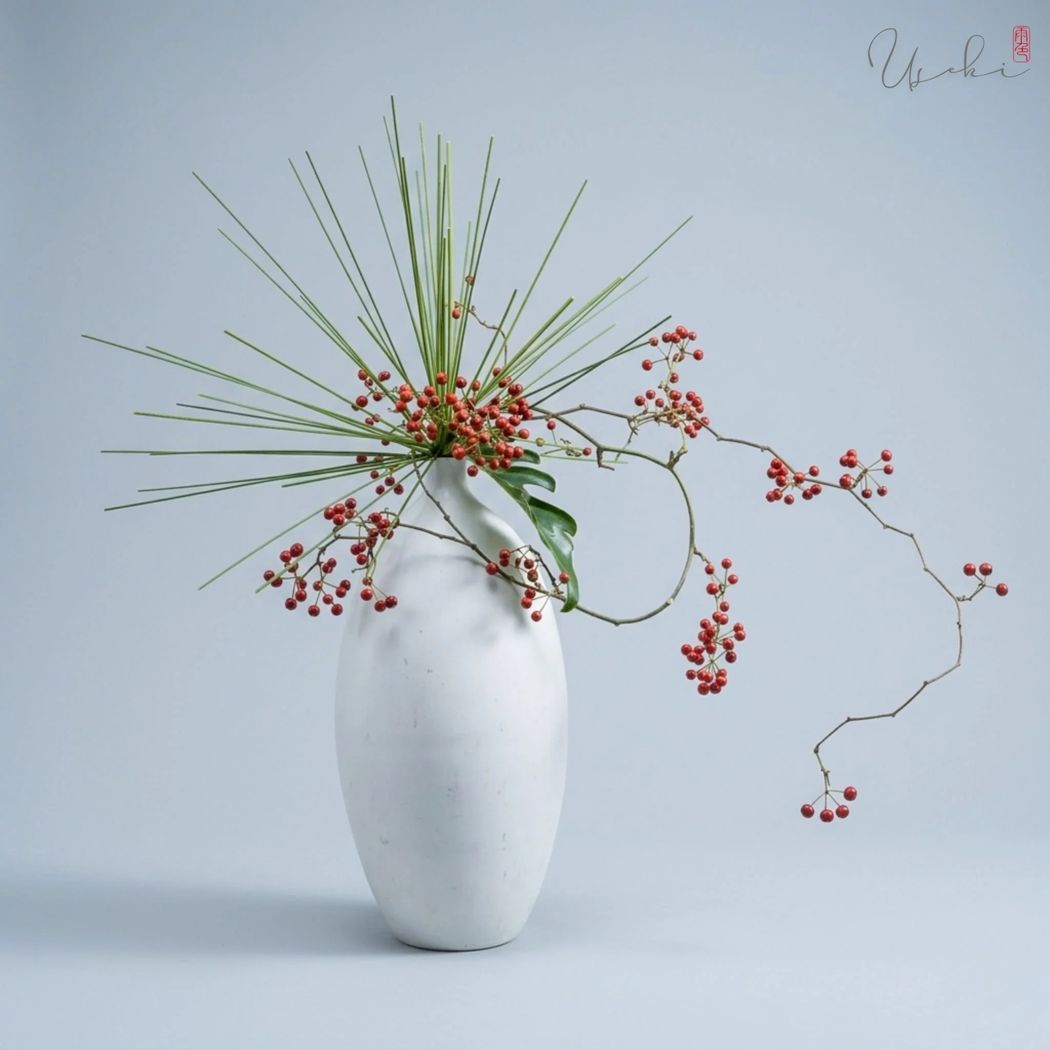 Sogetsu Ikebana minimalist tall white vase arrangement with delicate red berries and thin stems