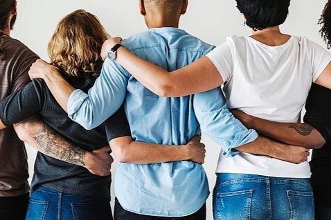 diverse group of people holding their arms around each other.jpg