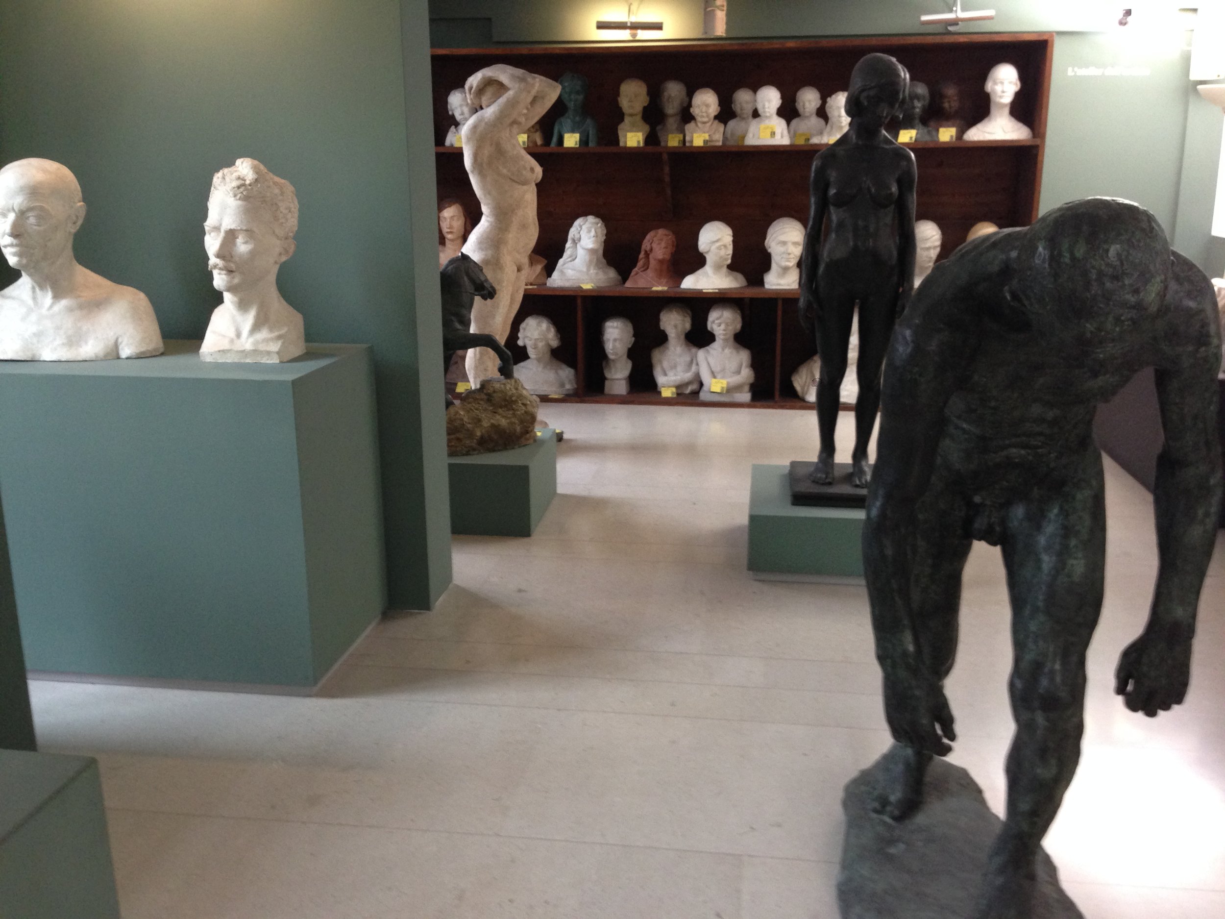 Sculpture of a brooding man, one of Rodin's, sulking with other sculptures surrounding him