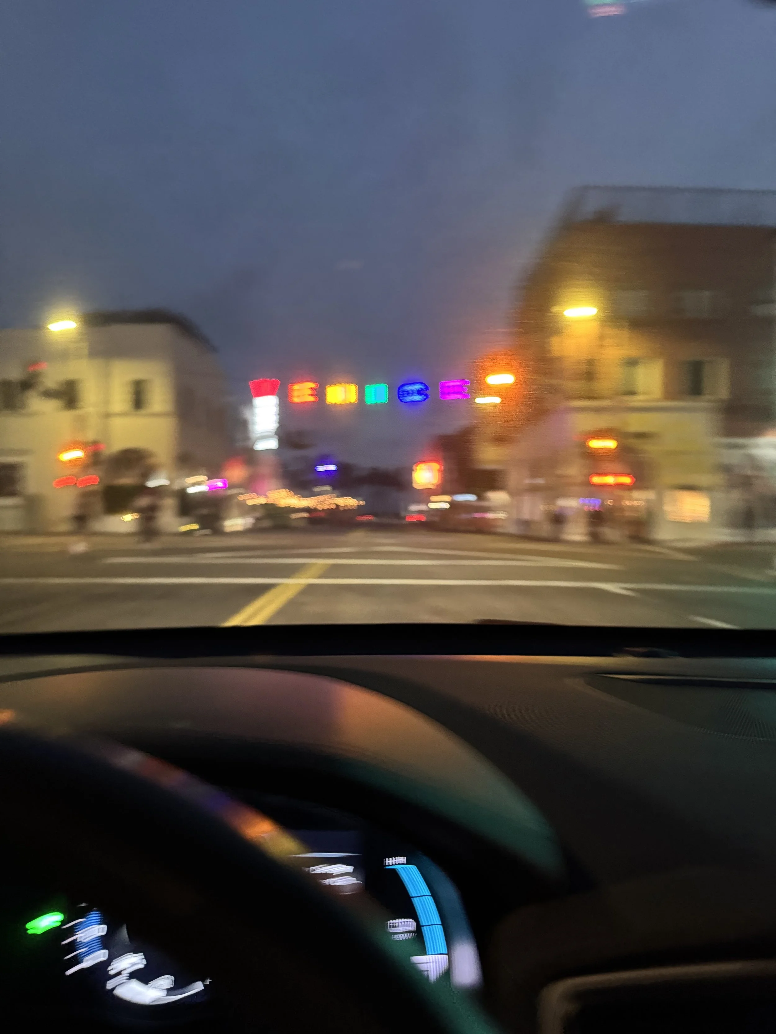 Blurry photo that looks out of focus and scattered, taken from behind the wheel of a car