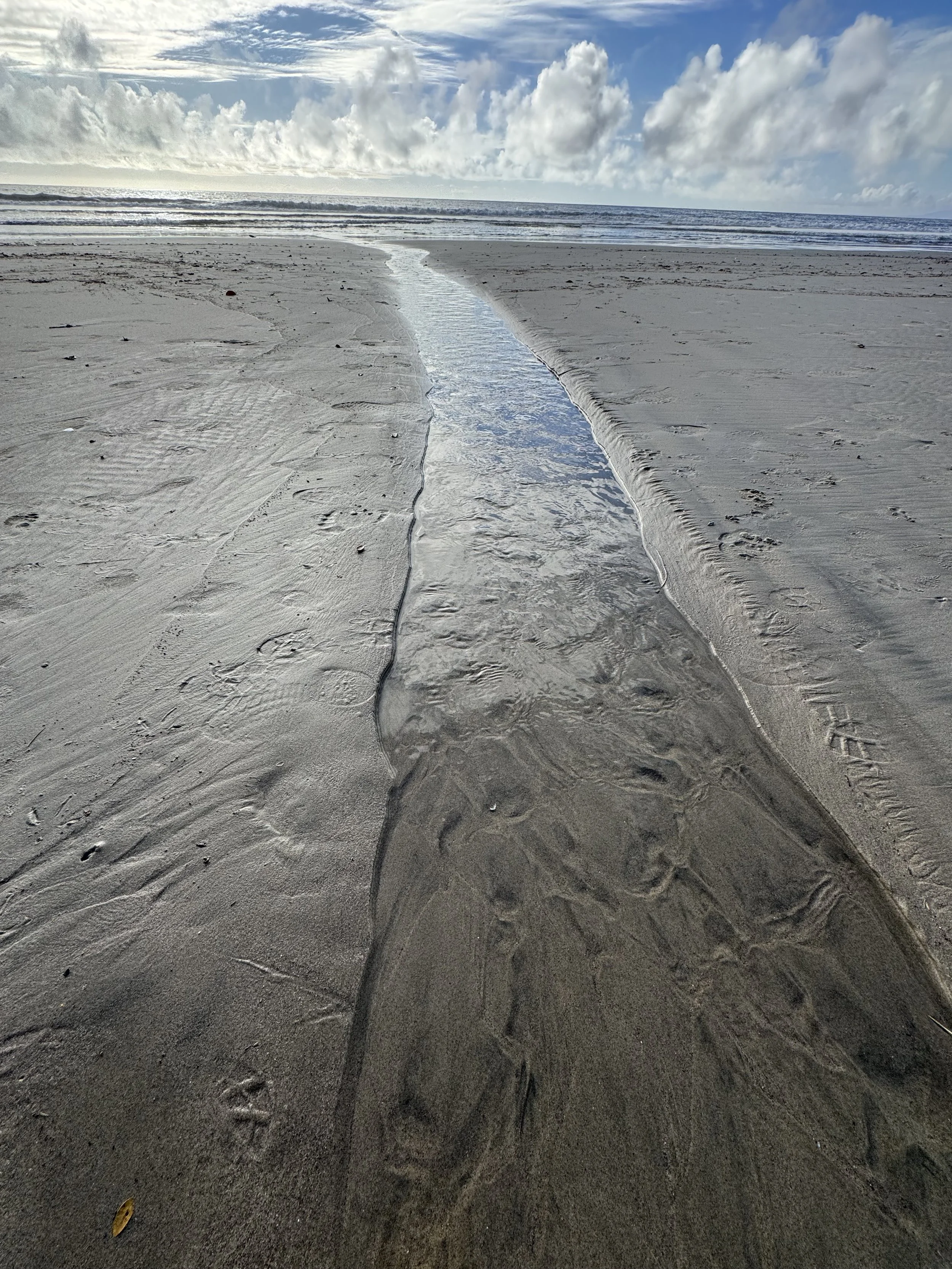 A stream of water runs out to the vast ocean