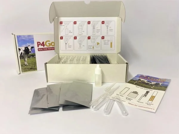 Fertility testing kit with bottles, test strips, instruction sheet, and packaging.