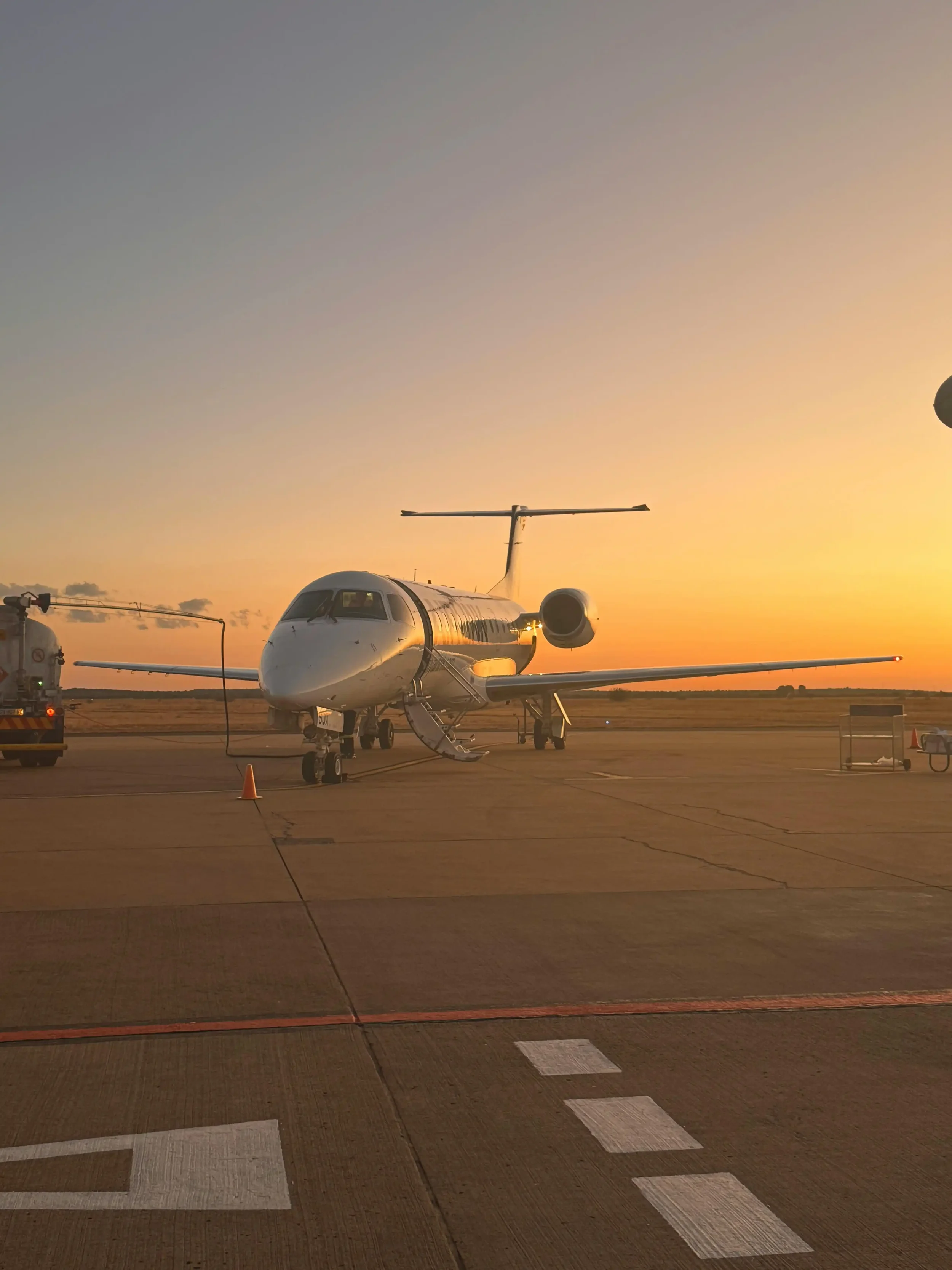 usiness jet on airport ramp at sunset with stairs deployed preparing for international departure requiring aircraft disinsection