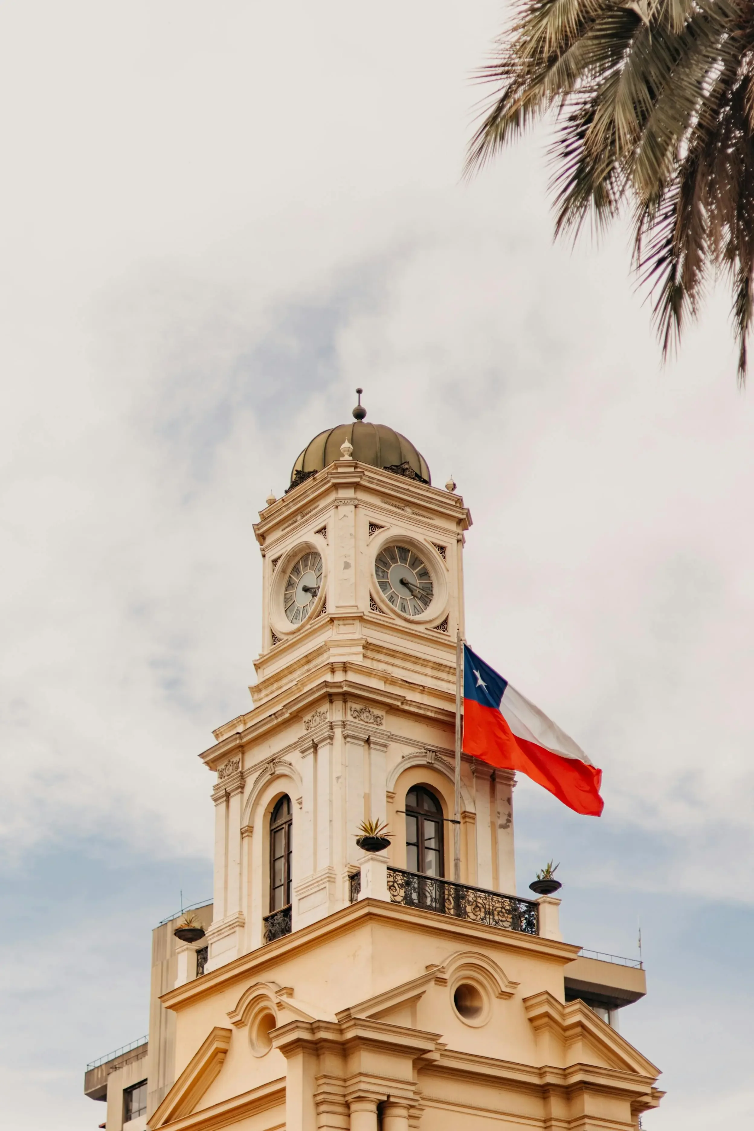 Chilean flag over historic Santiago building representing Chile as an international aviation destination requiring aircraft disinsection