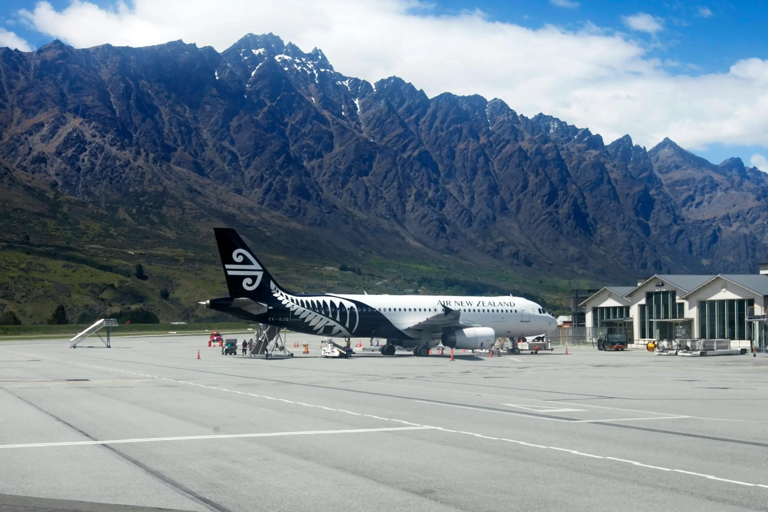 Air New Zealand aircraft at Queenstown Airport with the Remarkables mountains where all international arriving flights require aircraft disinsection