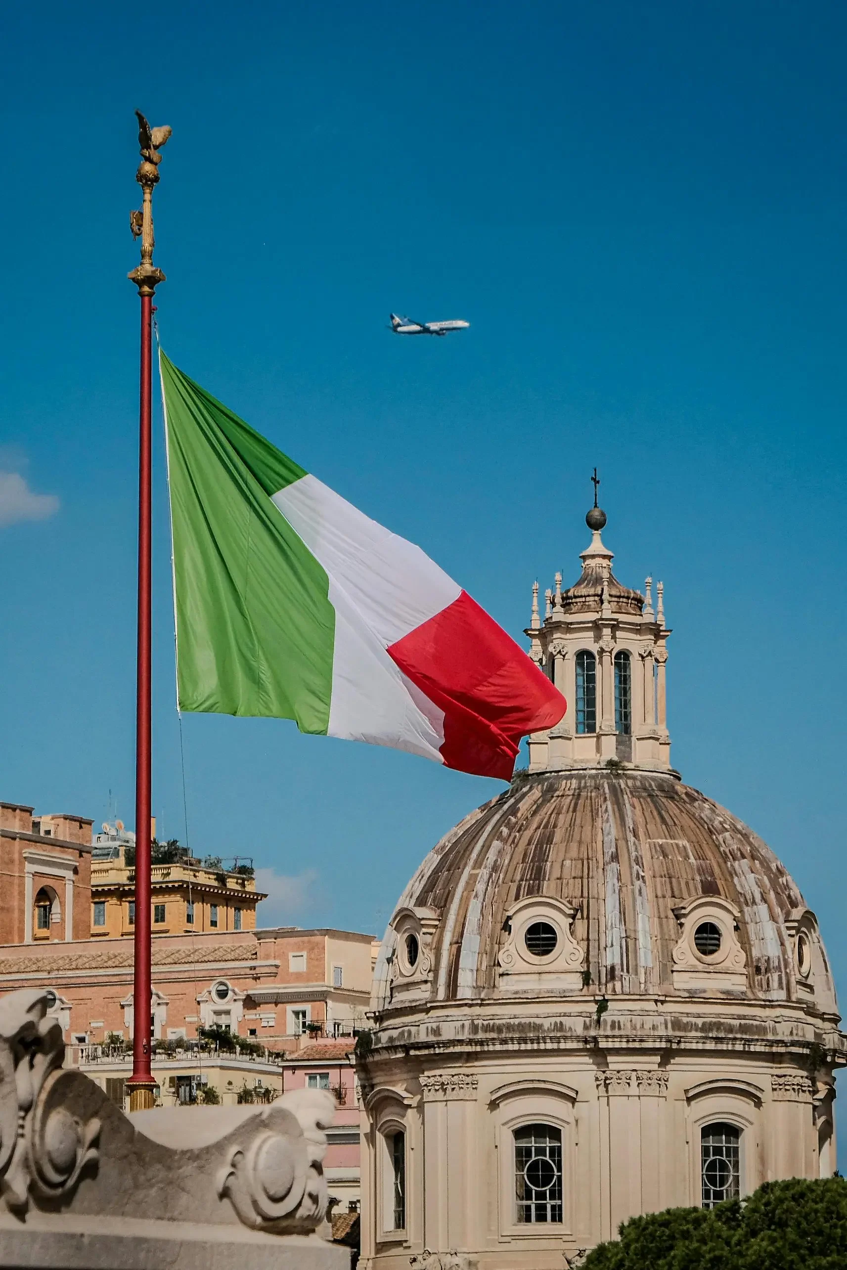 Italian flag over Rome with aircraft overhead representing Italy aircraft disinsection requirements for international arrivals