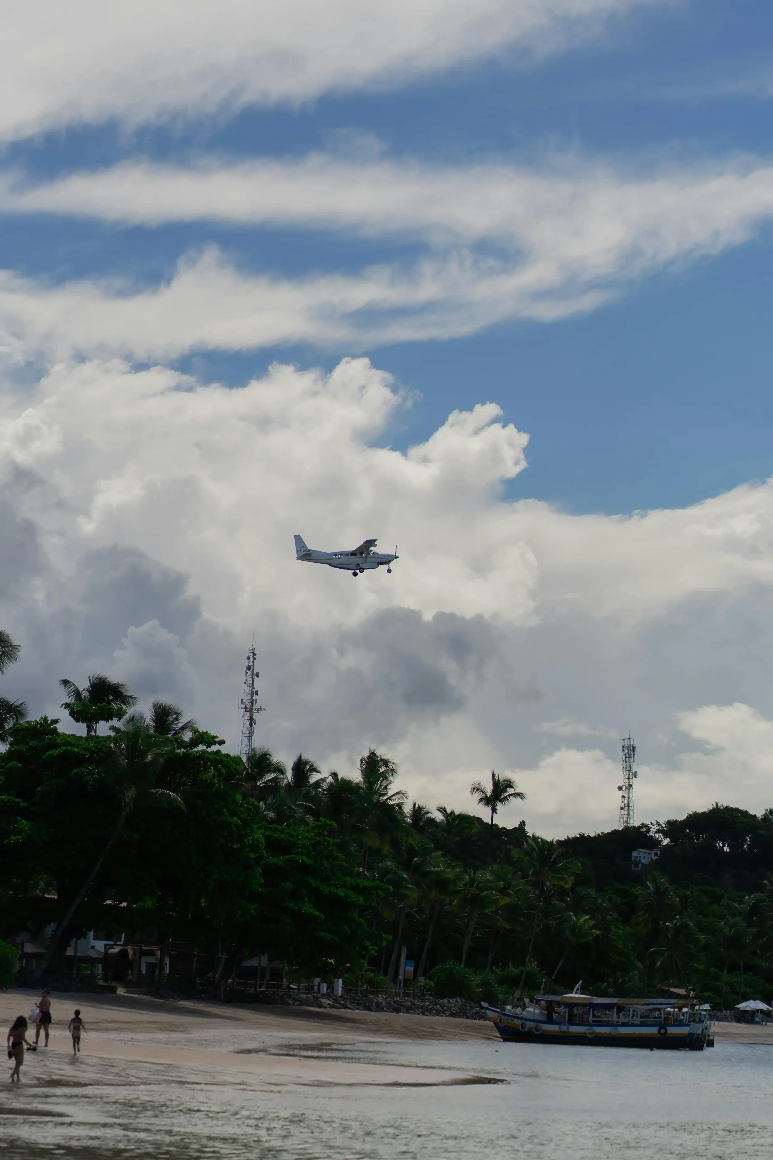 Small aircraft arriving over Cook Islands beach coastline where all international arriving flights require aircraft disinsection