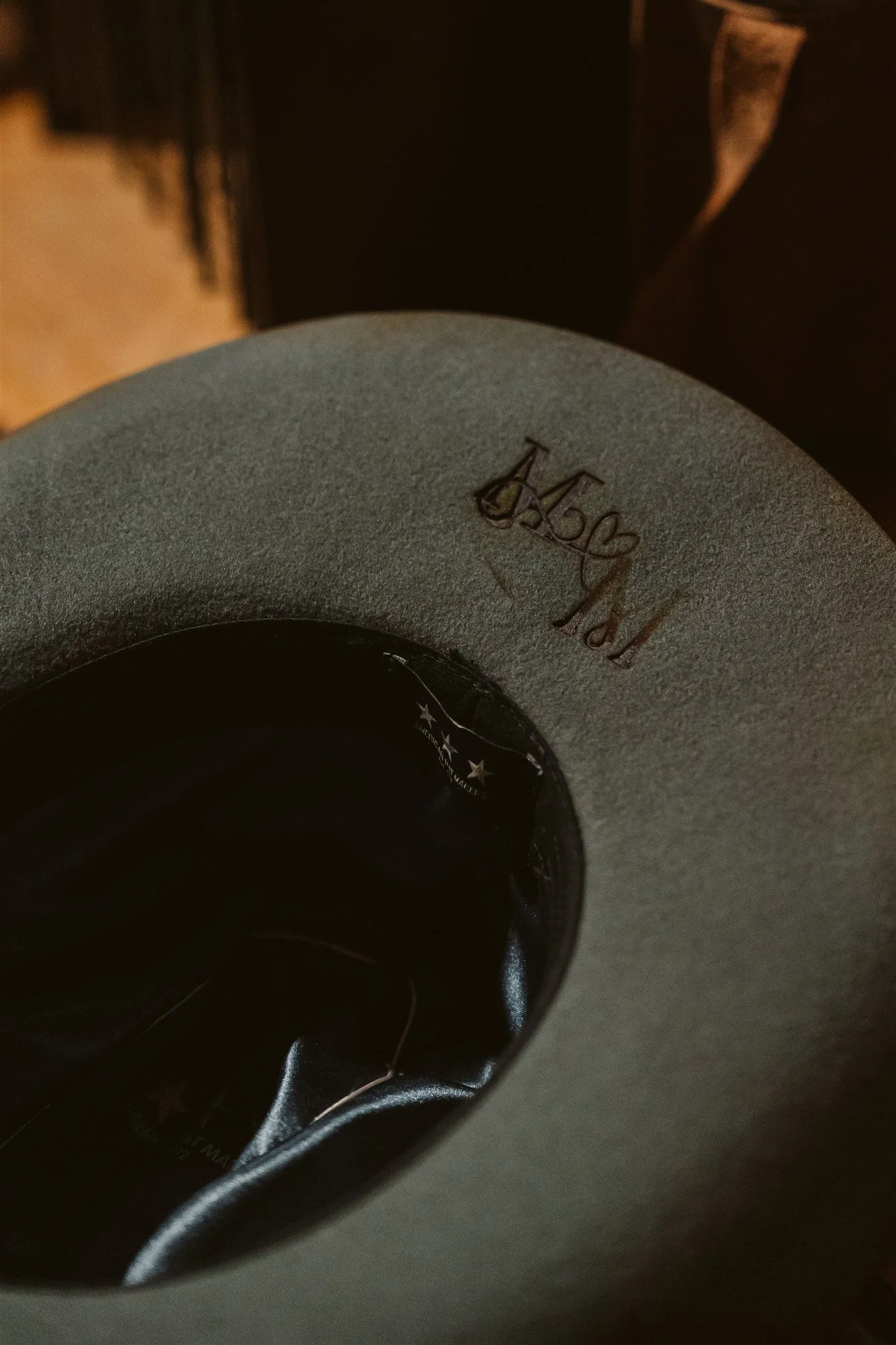 Close-up of a black and gray Sony earbud with the Sony logo and model number on the outer surface, with a black cord attached.